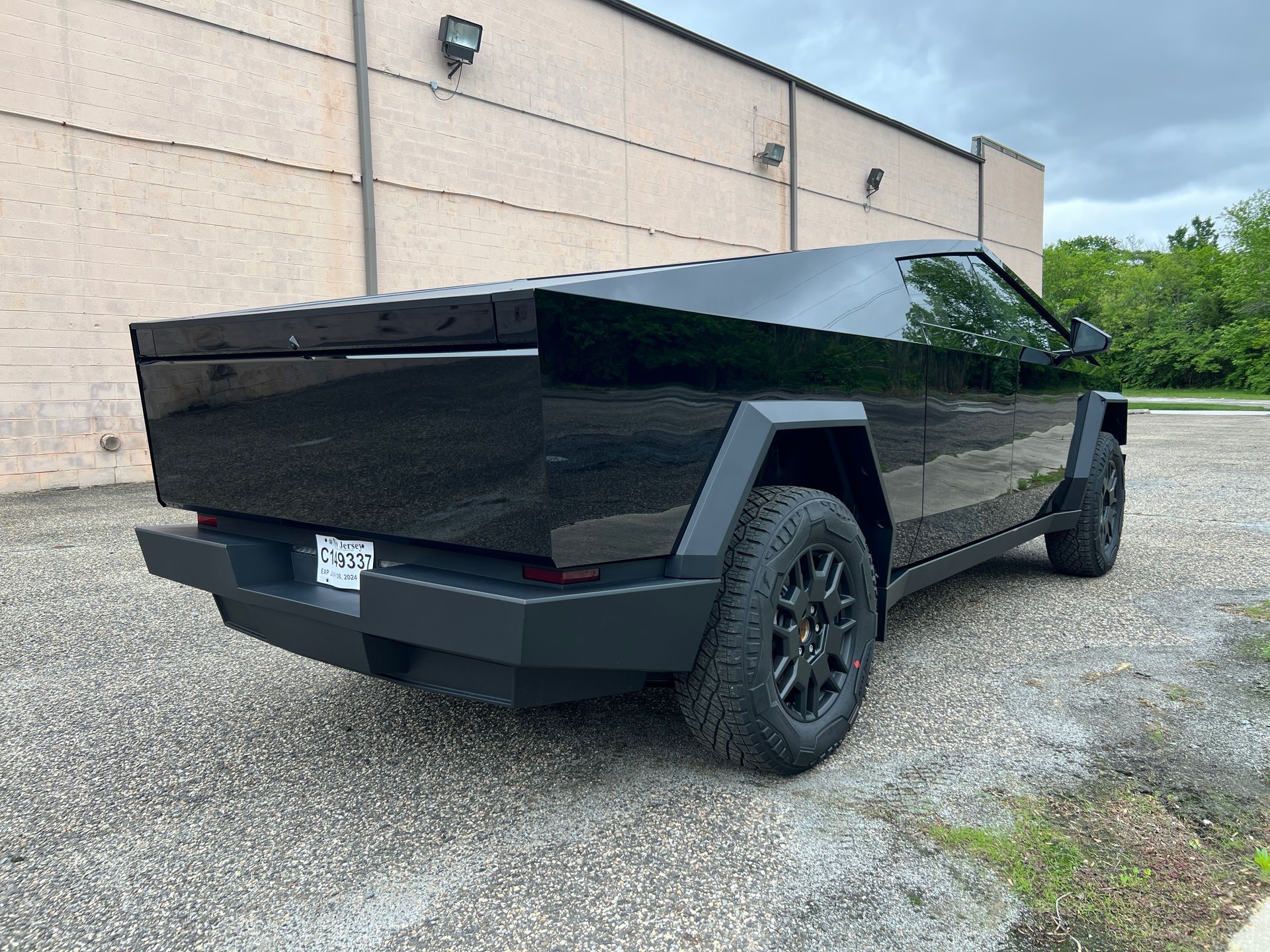 A black truck is parked in front of a building.
