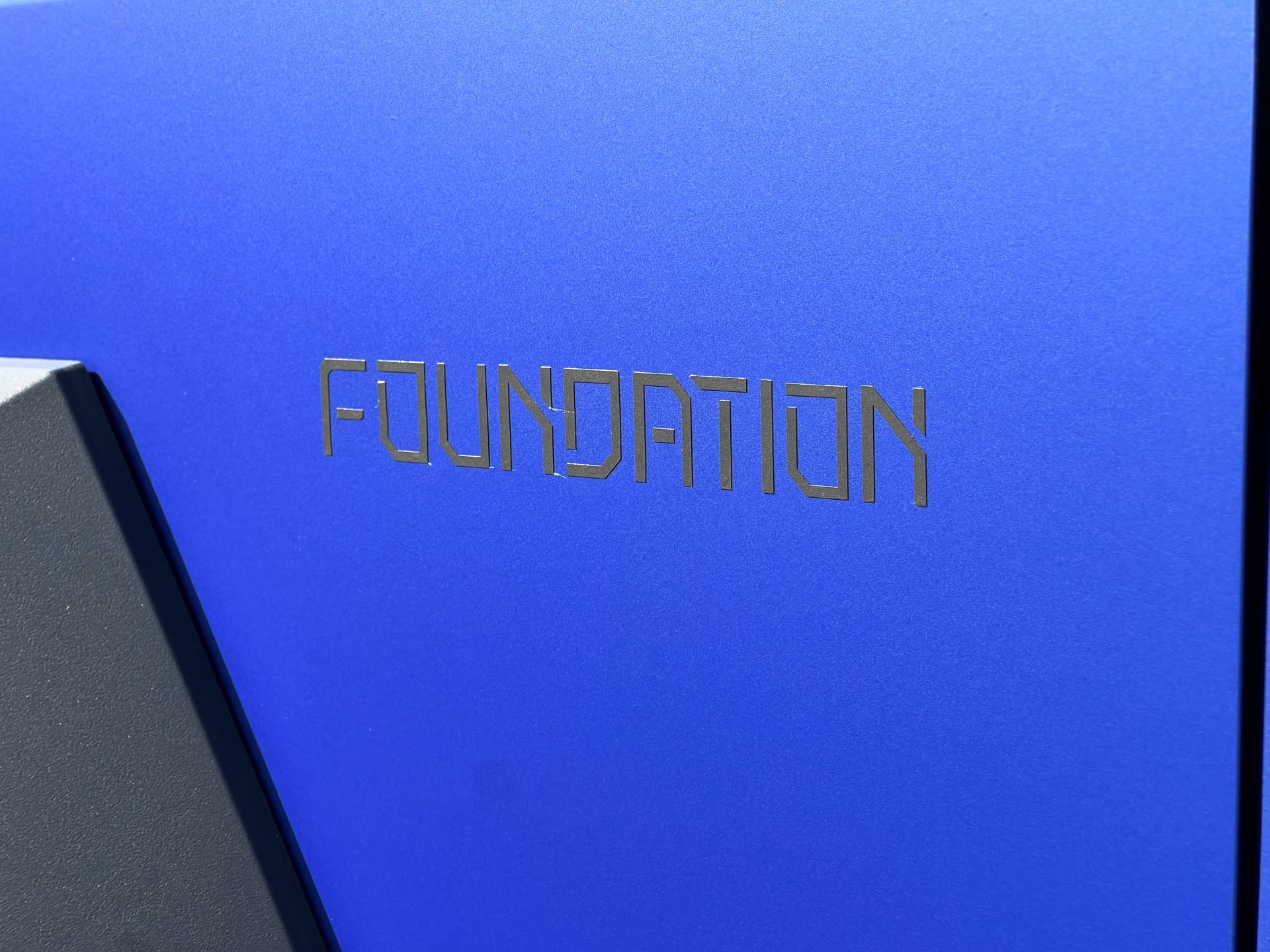 The word foundation that is on a blue surface