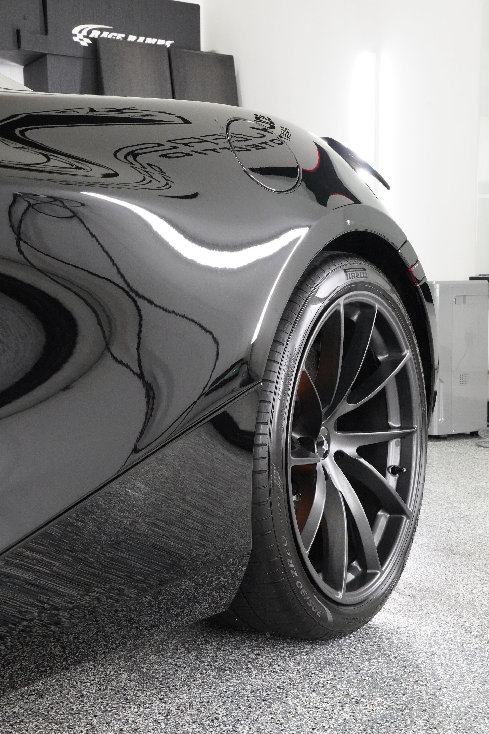 A close up of a car wheel in a garage