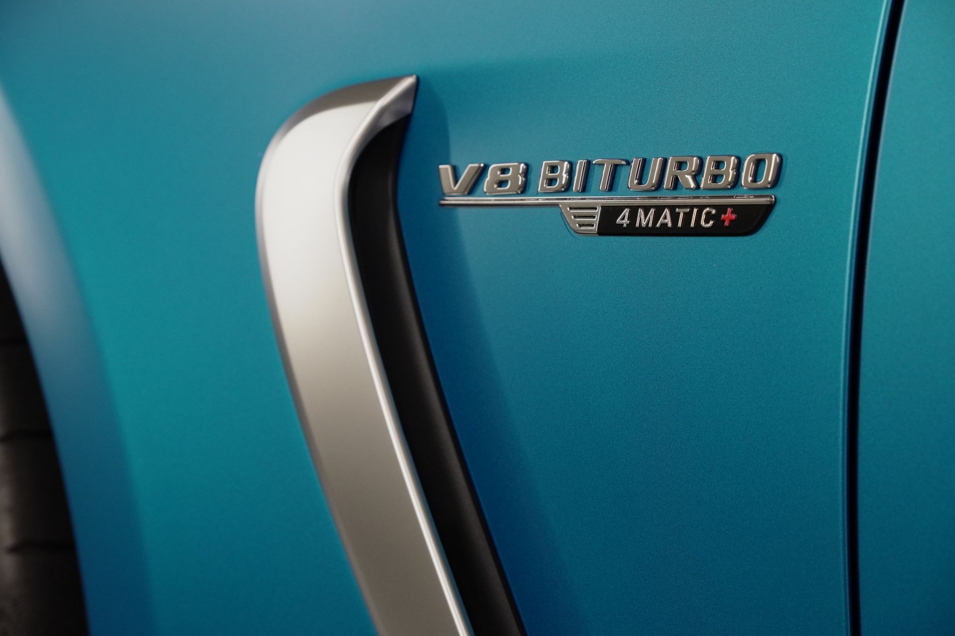 A close up of a blue car with the word turbo on it