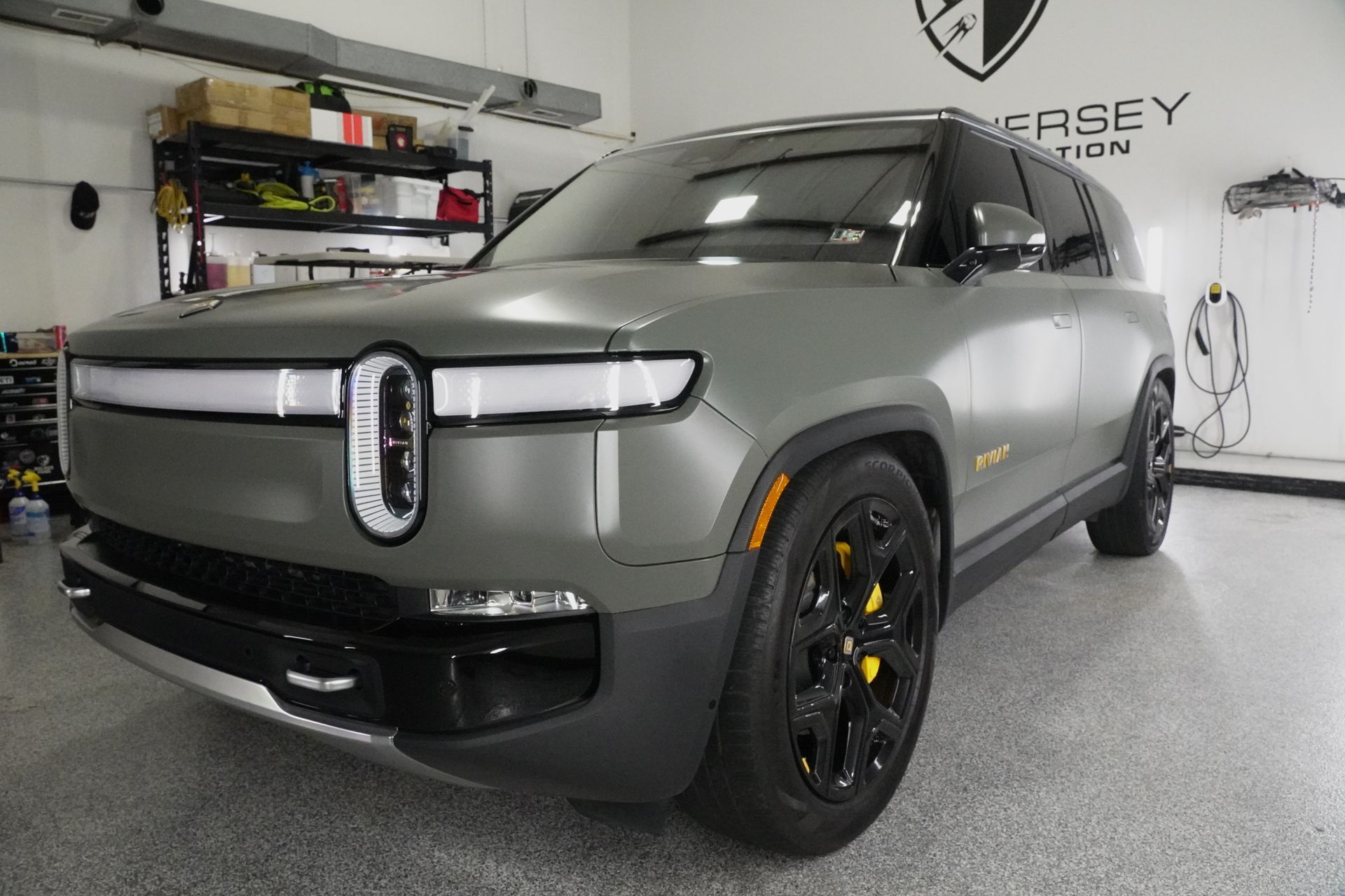 A gray suv is parked in a garage.