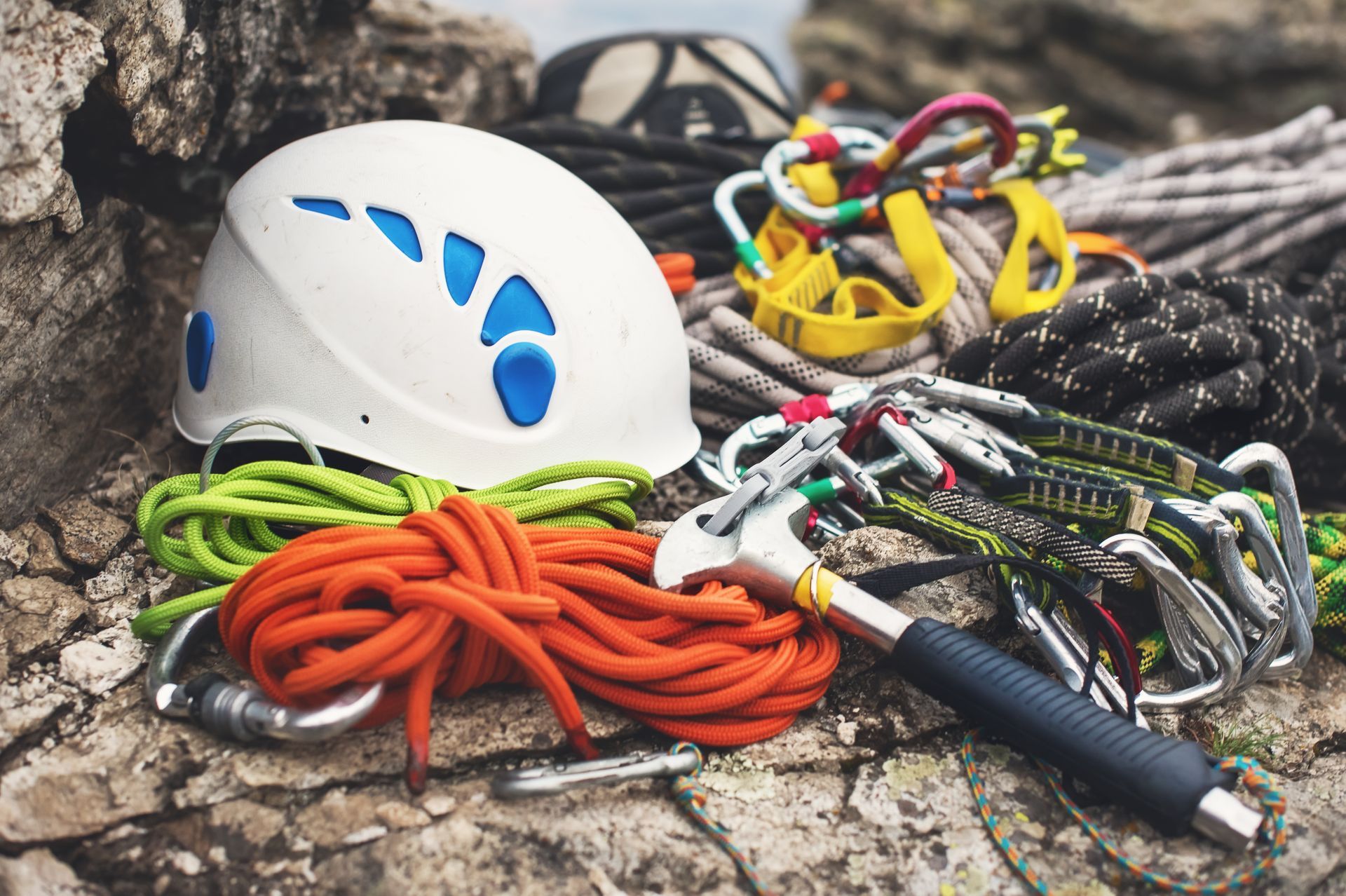 A helmet is sitting on top of a pile of climbing gear.