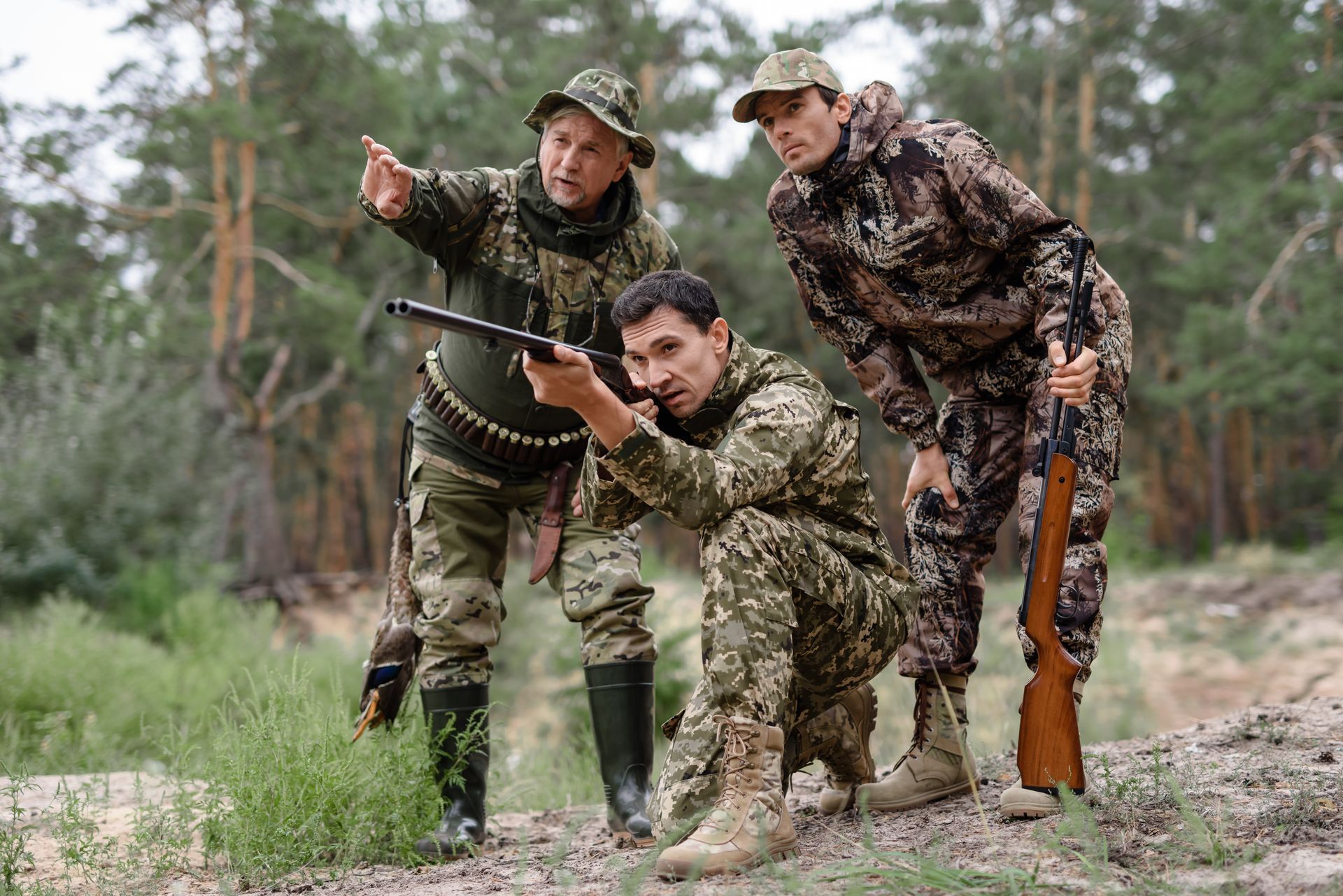 A group of soldiers are standing next to each other in the woods.