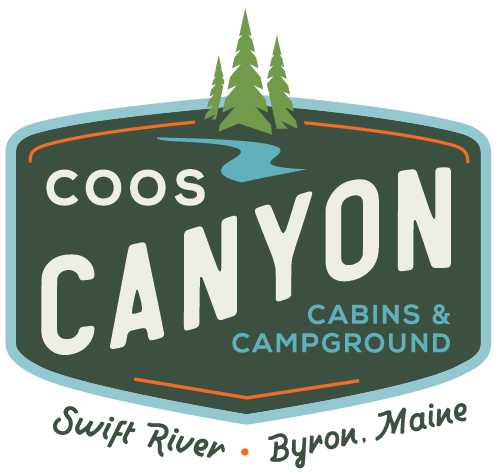 The logo for coos canyon cabins and campground.