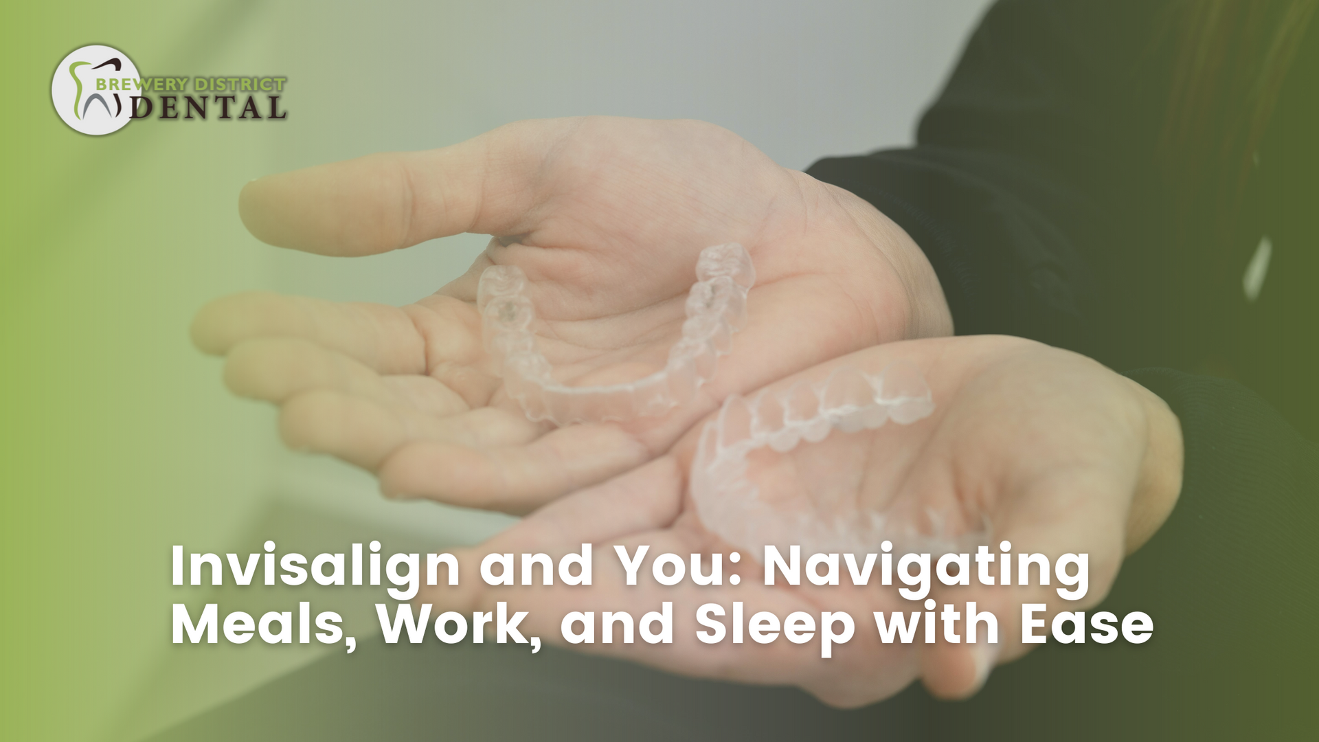 A person is holding a clear retainer in their hands.