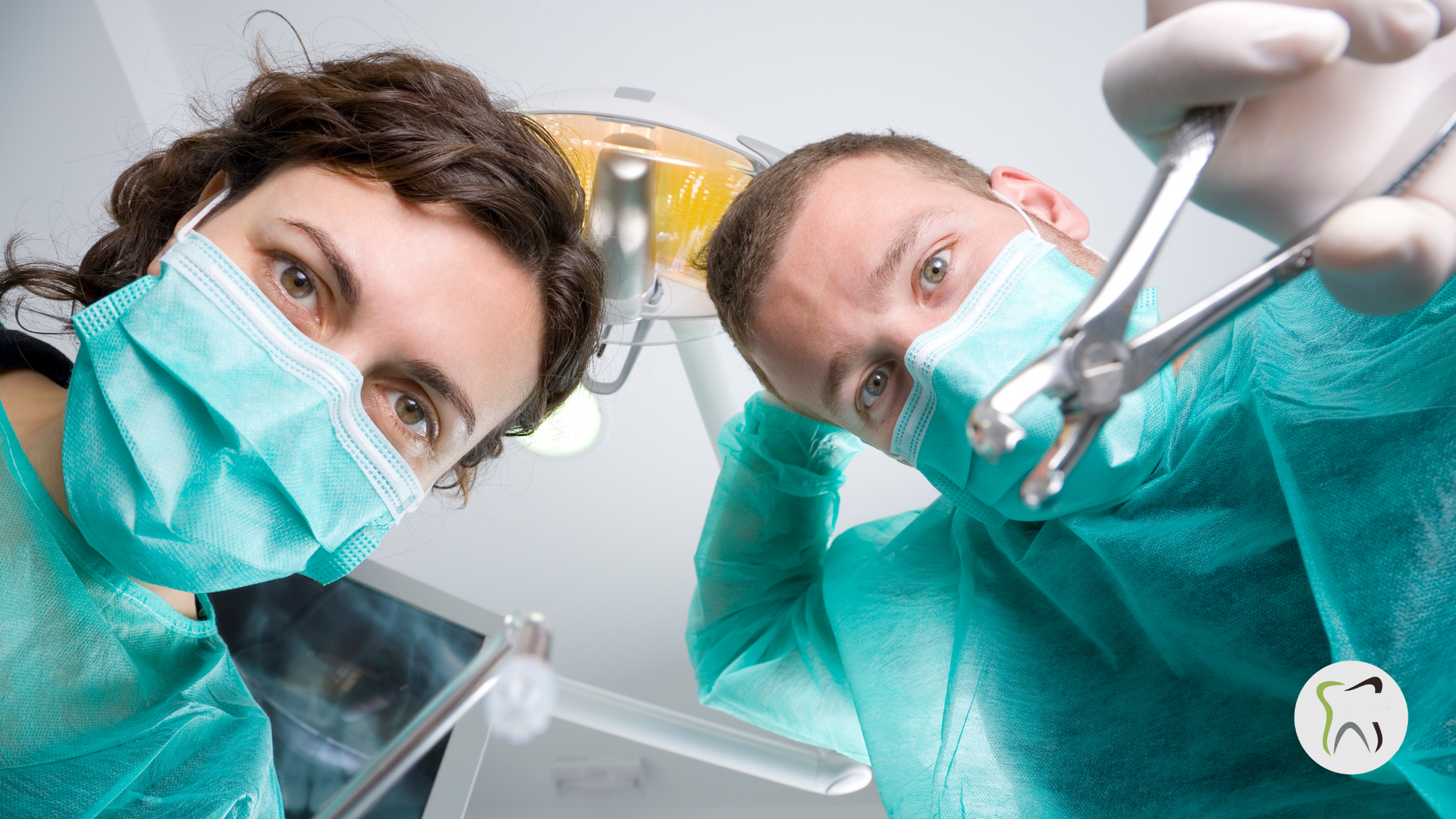 A man and a woman are looking at the camera while wearing surgical masks.