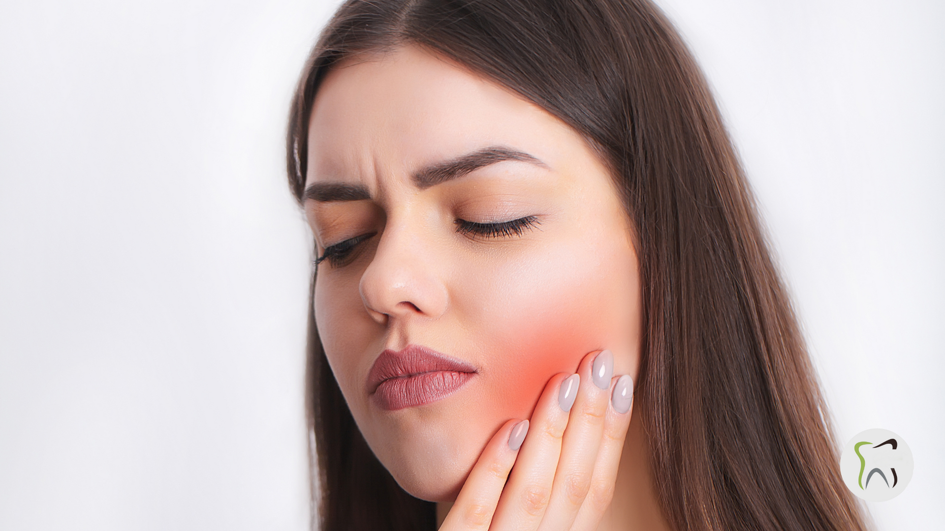 A woman is holding her face in pain because of a toothache.