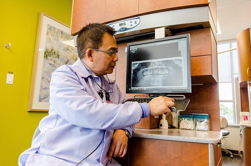 Dr. Francis Yeung | Dentist Looking At A Digital X-Ray