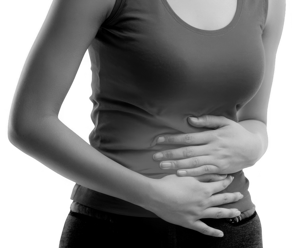 Woman holding her abdomen, indicating possible abdominal pain. Woman holding her abdomen, indicating possible abdominal pain.