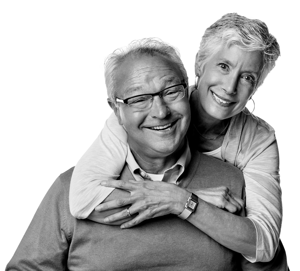 Smiling couple embracing, woman's arms around man's shoulders. Both are wearing glasses and appear happy. Smiling couple embracing, woman's arms around man's shoulders. Both are wearing glasses and appear happy.