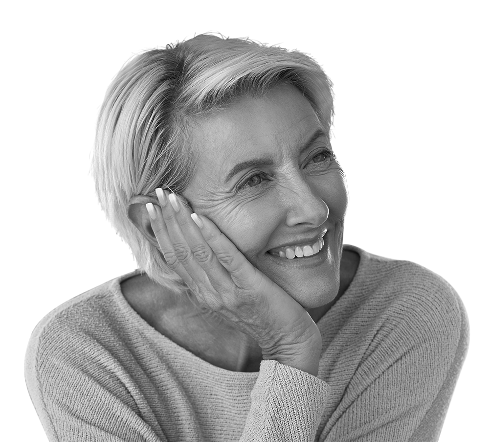 Woman with short blonde hair smiling, resting her cheek on her hand. Woman with short blonde hair smiling, resting her cheek on her hand.