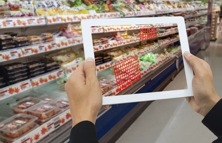 Hands holding a tablet displaying a grocery store shelf, blending digital and real-world scenes.