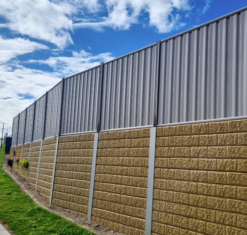 A Wooden Fence Is Sitting in The Middle of A Grassy Field — Quality Fencing Solutions in Ballina, NSW