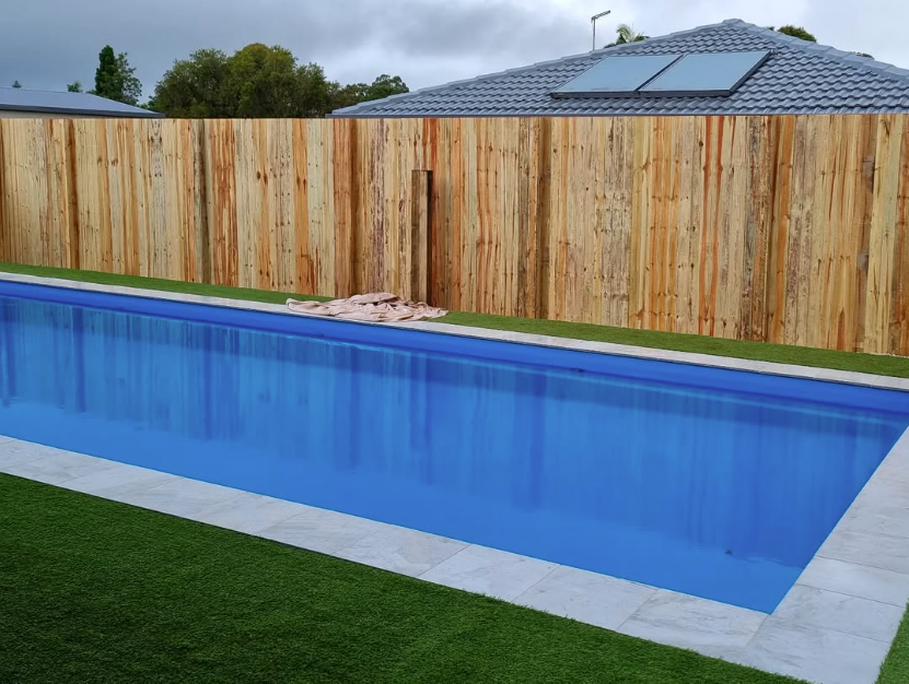 A Wooden Fence Is Being Built in A Backyard — Quality Fencing Solutions in Ballina, NSW