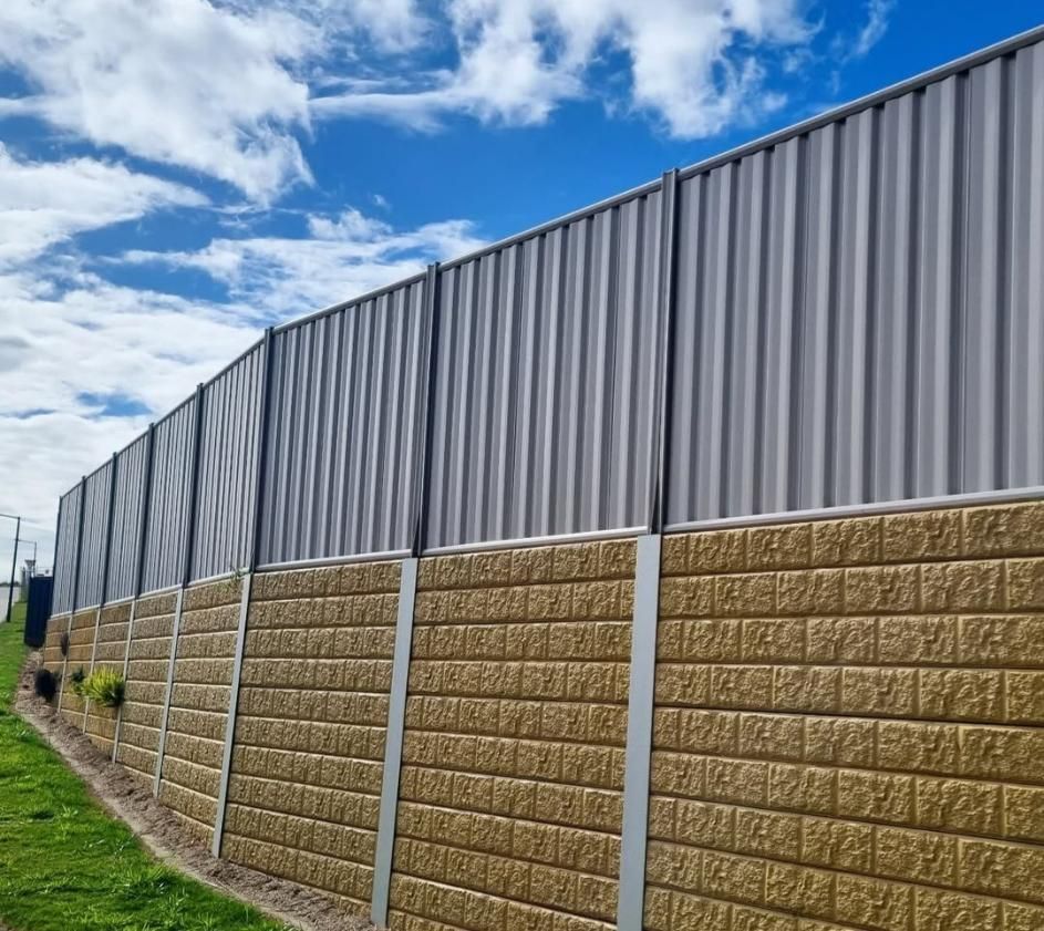 A Fence Made of Bricks and A Metal Fence with A Blue Sky in The Background — Quality Fencing Solutions in Ballina, NSW