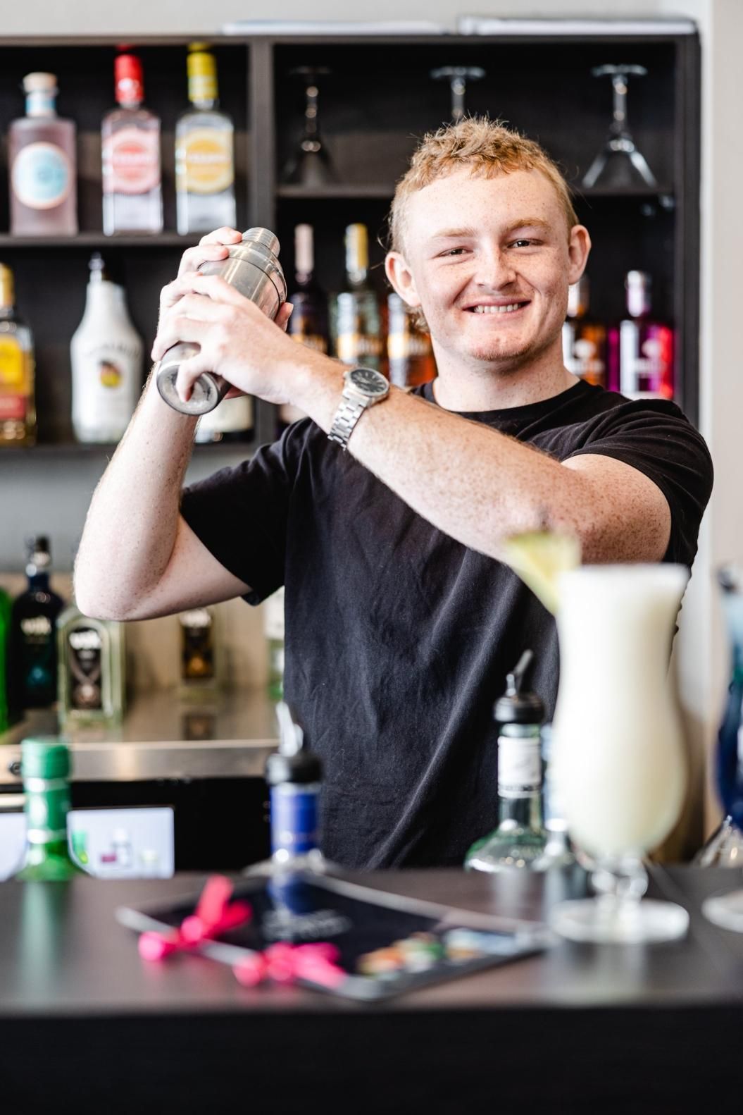 A Young Man Is Shaking A Drink In A Bar — Mod Thai Nelson Bay In Nelson Bay, NSW