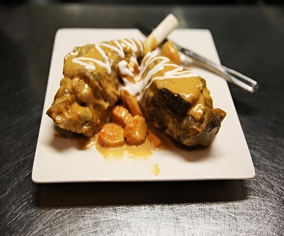 A White Plate Topped With Meat And Carrots With A Fork — Mod Thai Nelson Bay In Nelson Bay, NSW