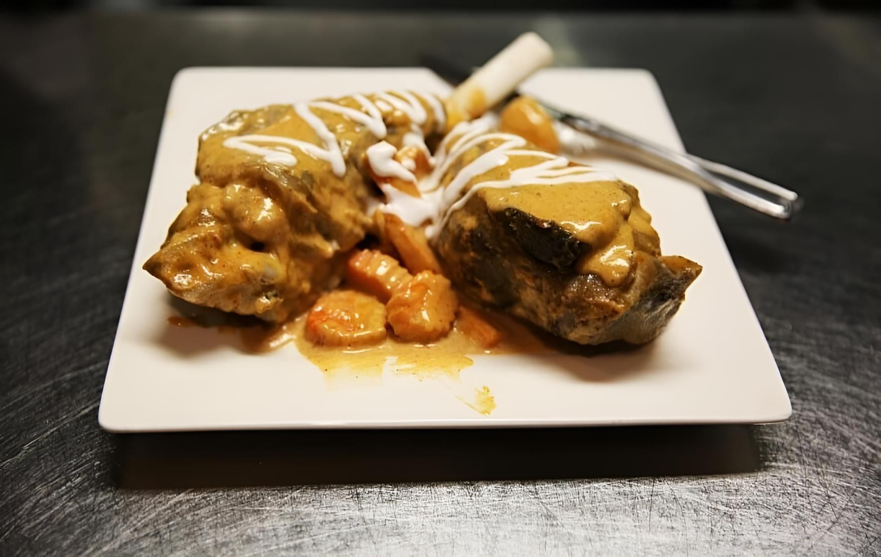 A White Plate Topped With Meat And Carrots With A Fork — Mod Thai Nelson Bay In Nelson Bay, NSW