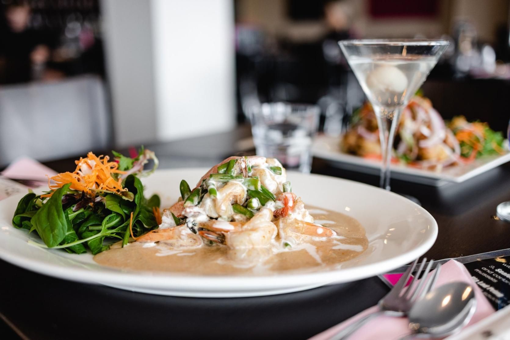 A Plate Of Food And A Martini Glass On A Table — Mod Thai Shoal Bay In Nelson Bay, NSW