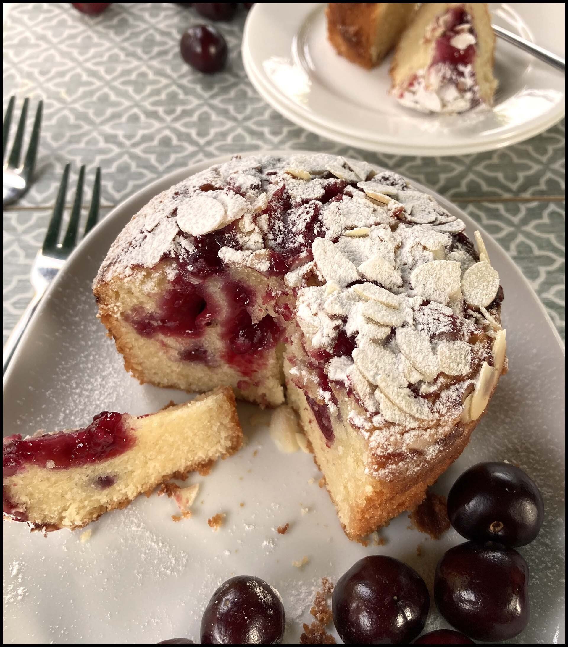 Cheery and Almond cake on a plate with cherries