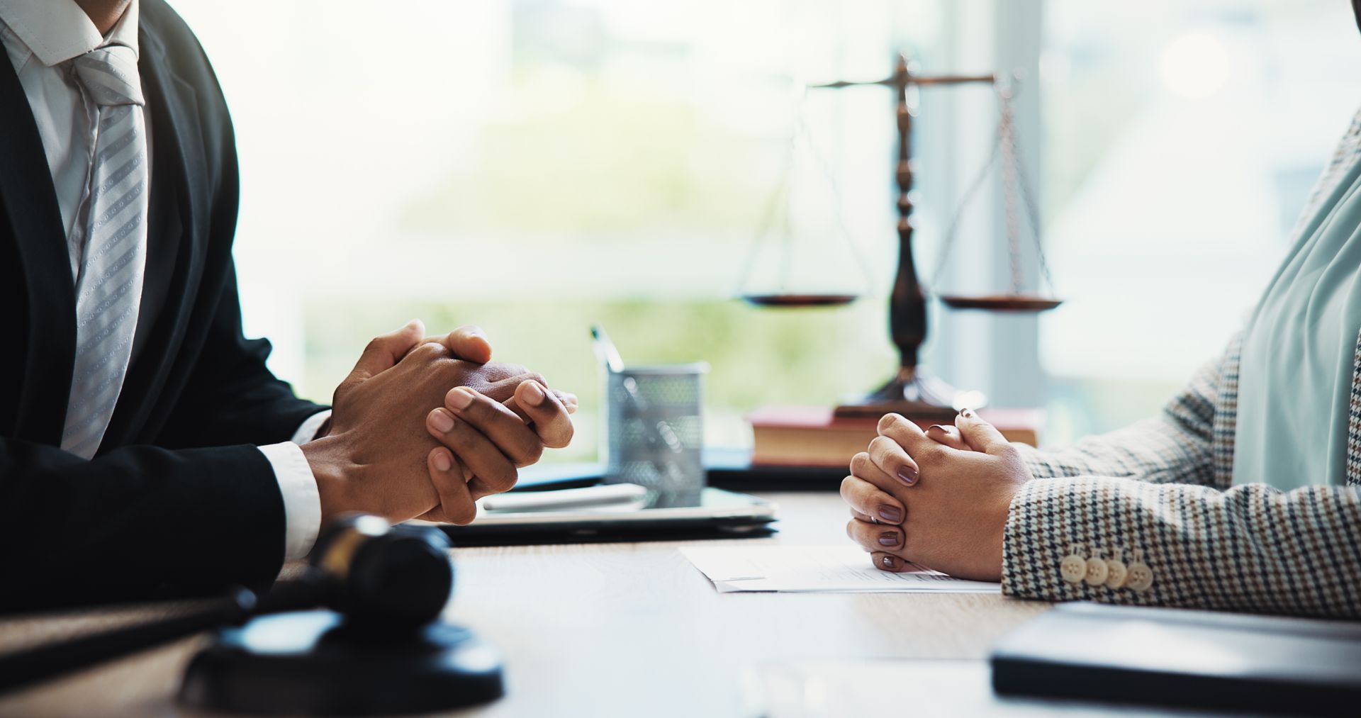 Gavel, lawyers, and hands of businesspeople in a meeting for legal consultation.