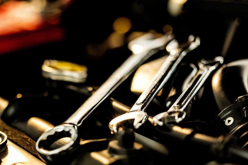 A Bunch of Wrenches Are Sitting on Top of a Car Engine — Ballina Bearing Supplies In Ballina, NSW