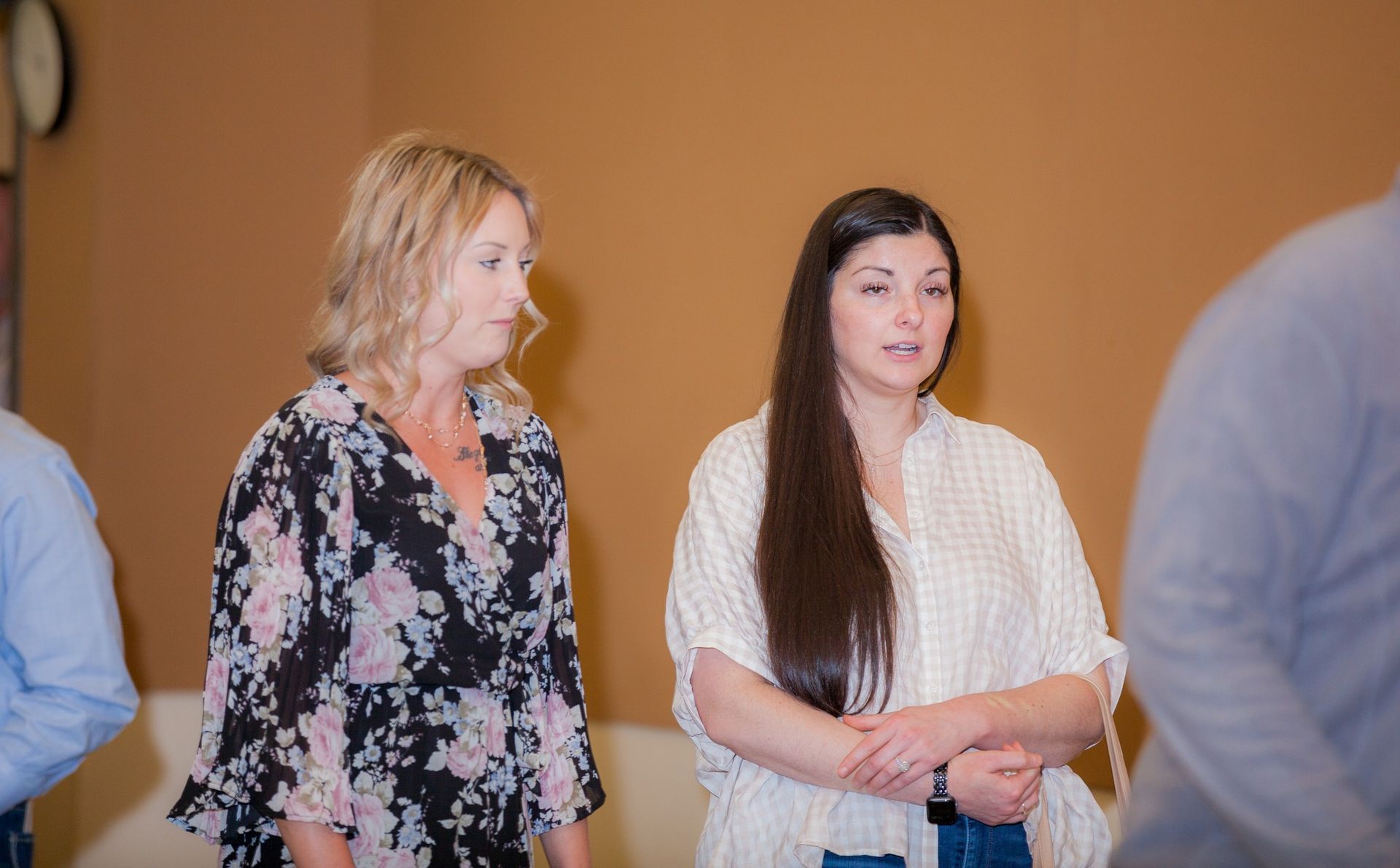 Two women are standing next to each other in a room.