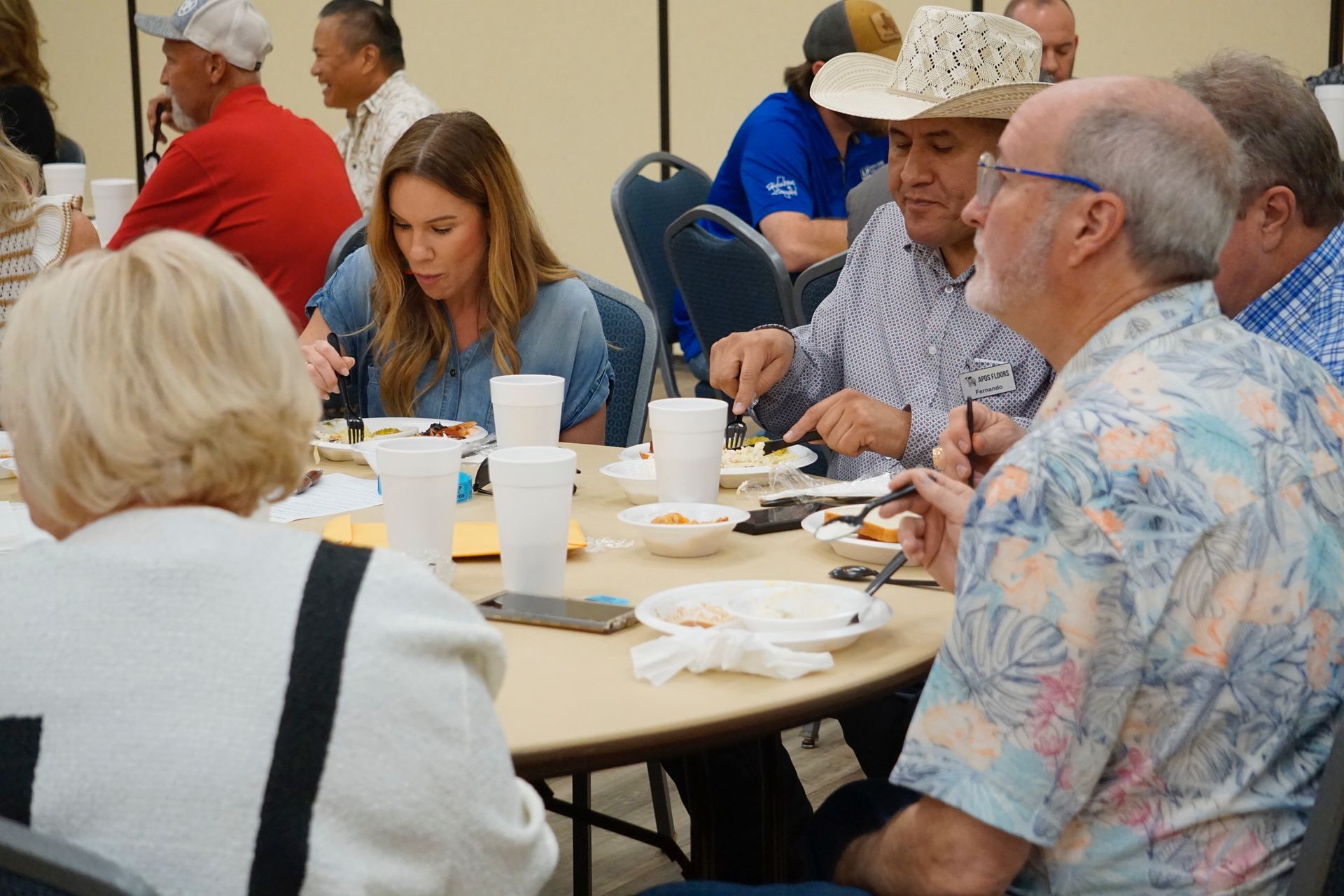 A group of people are sitting at a table eating food.