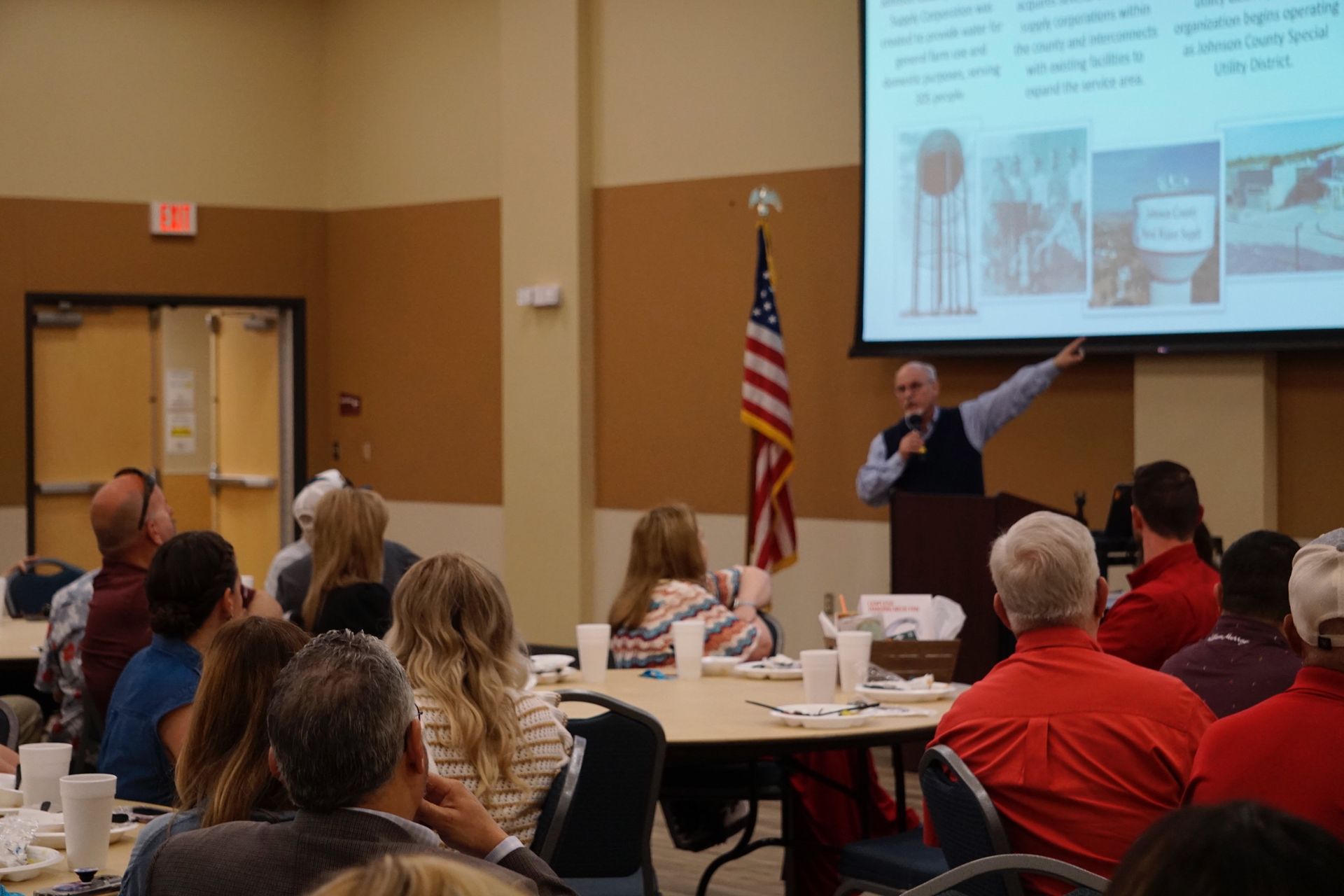 A man is giving a presentation to a group of people in a room.