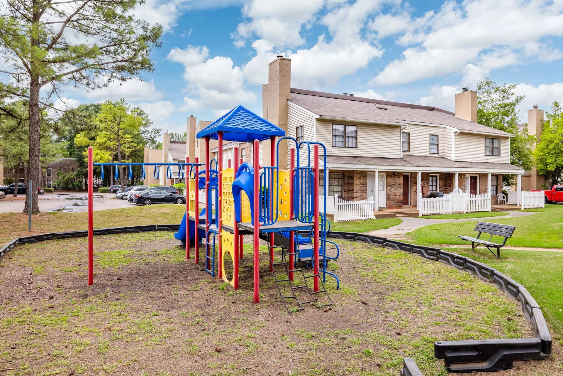 A colorful playground in front of a house in a residential area.