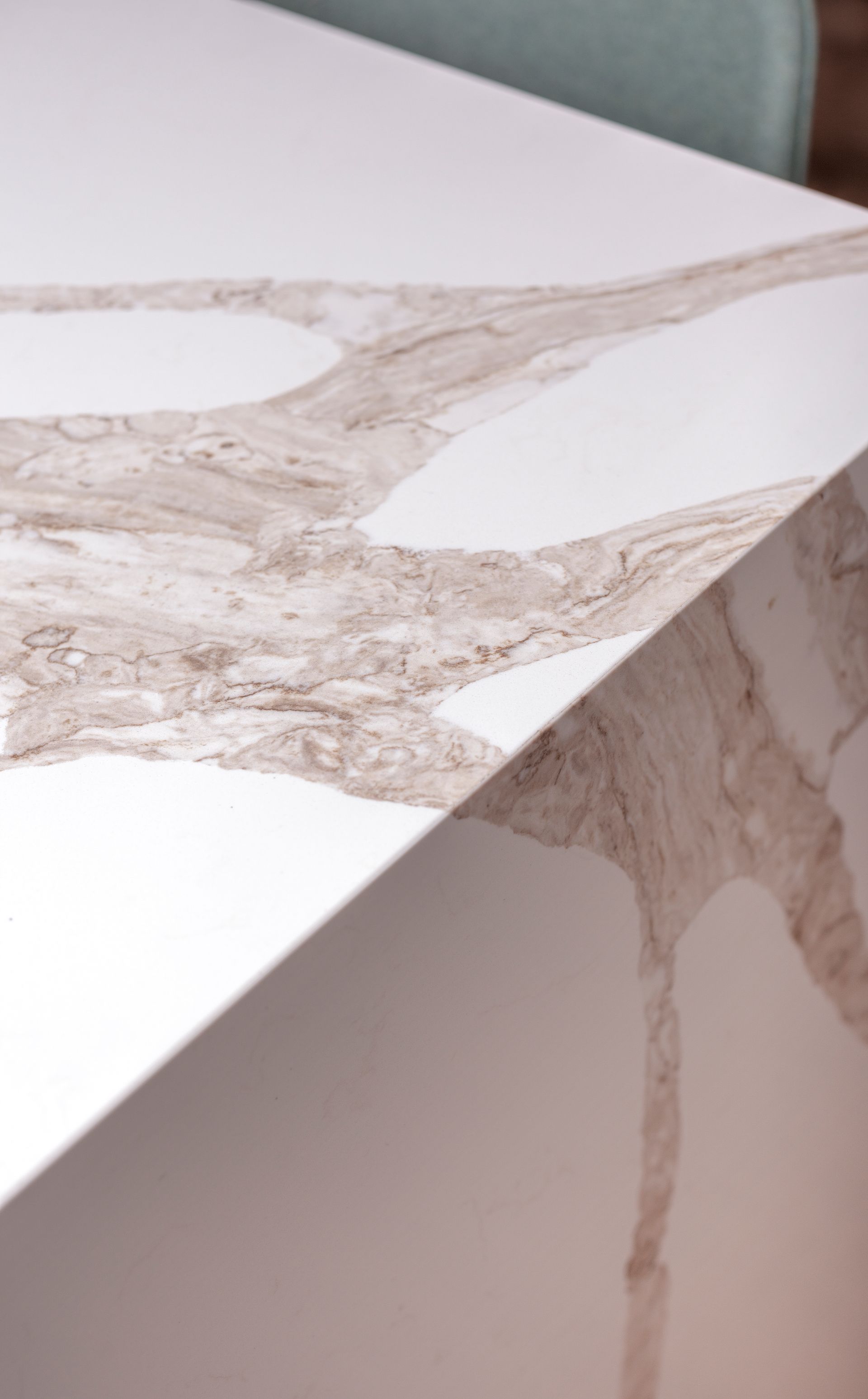 a close up of a white marble counter top in a kitchen .