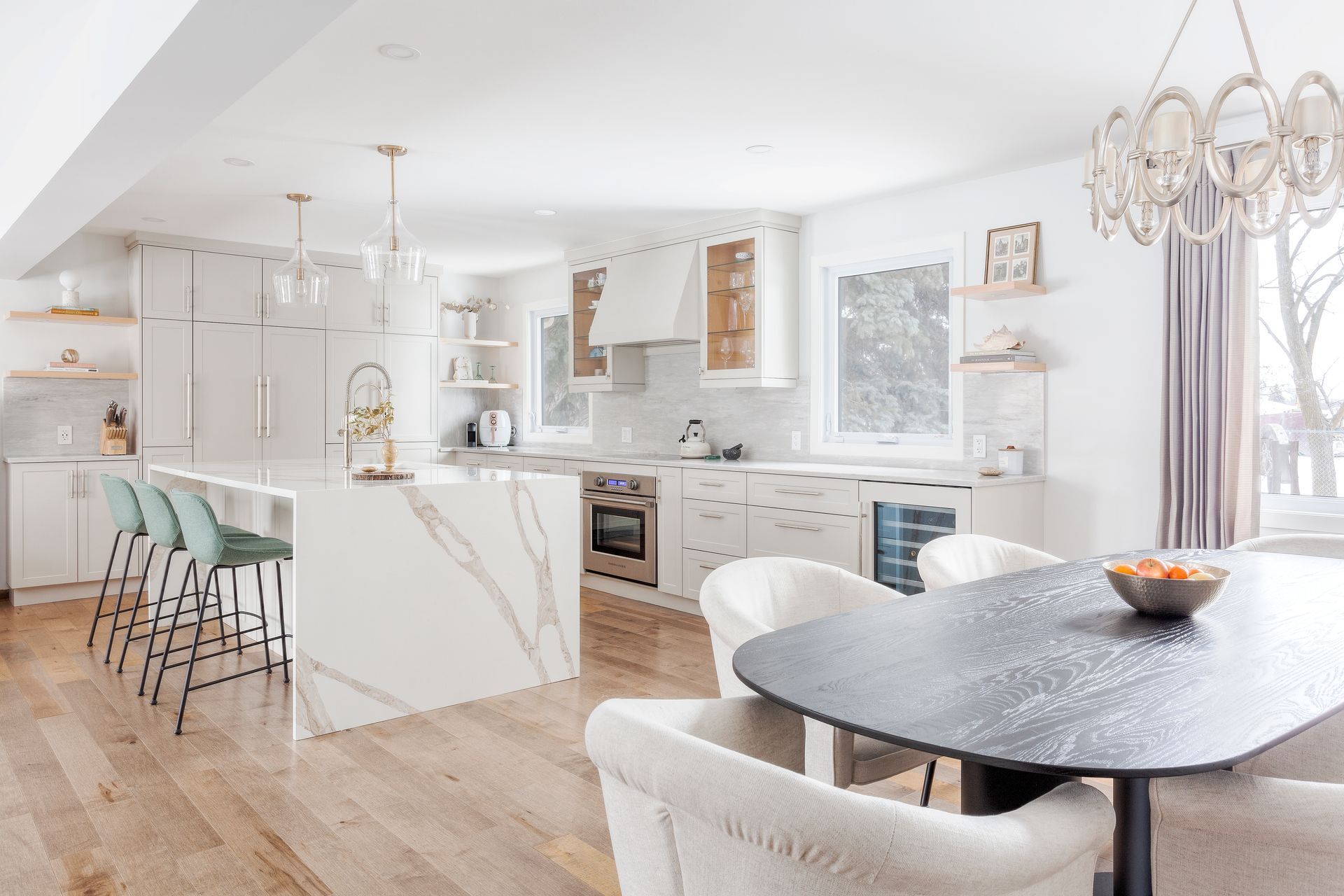 a kitchen and dining room in a house with a table and chairs .