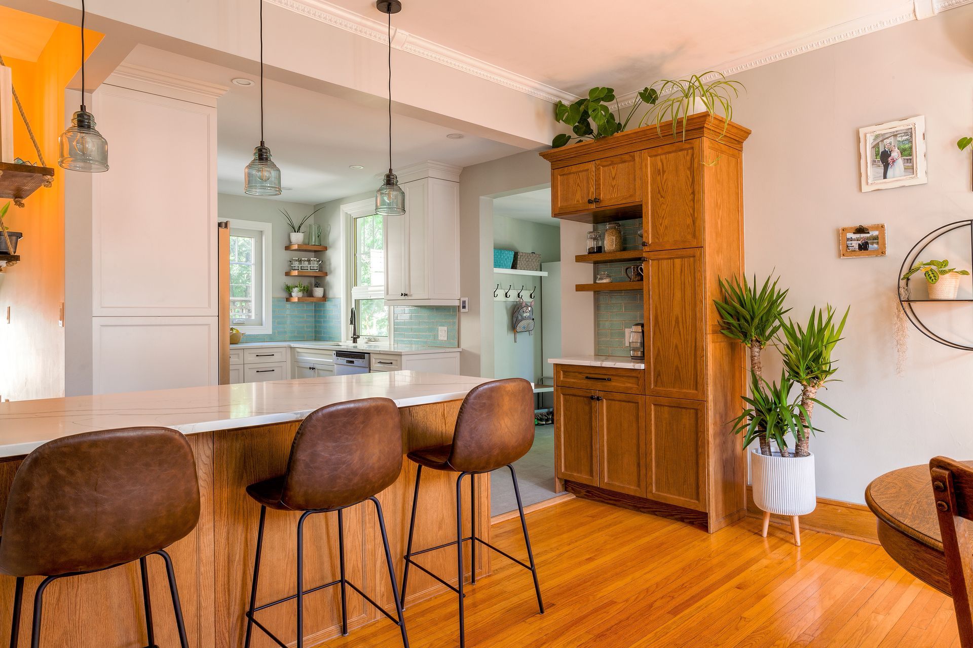 A kitchen with a bar and stools in it