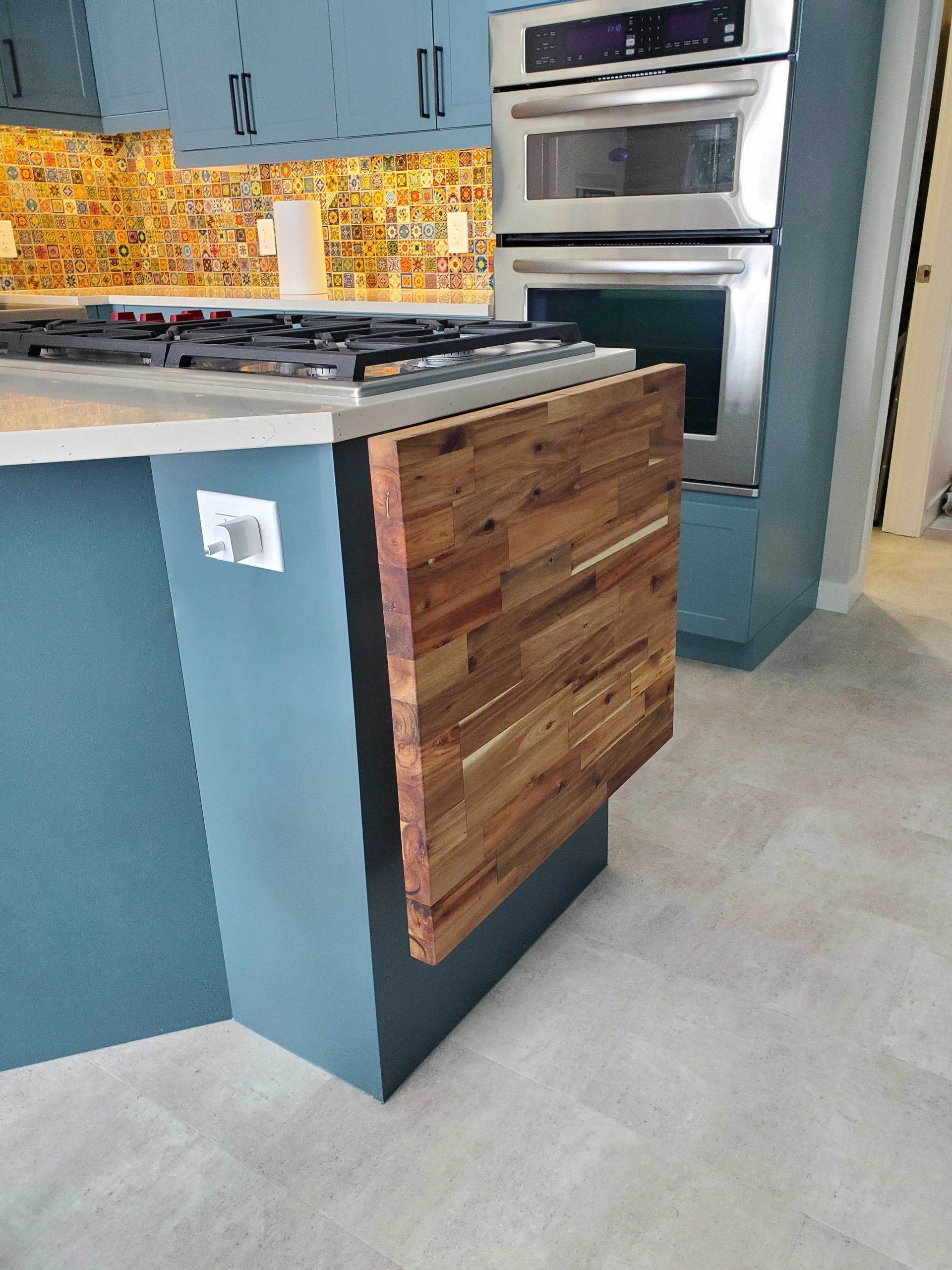 A kitchen with stainless steel appliances and a wooden counter top.