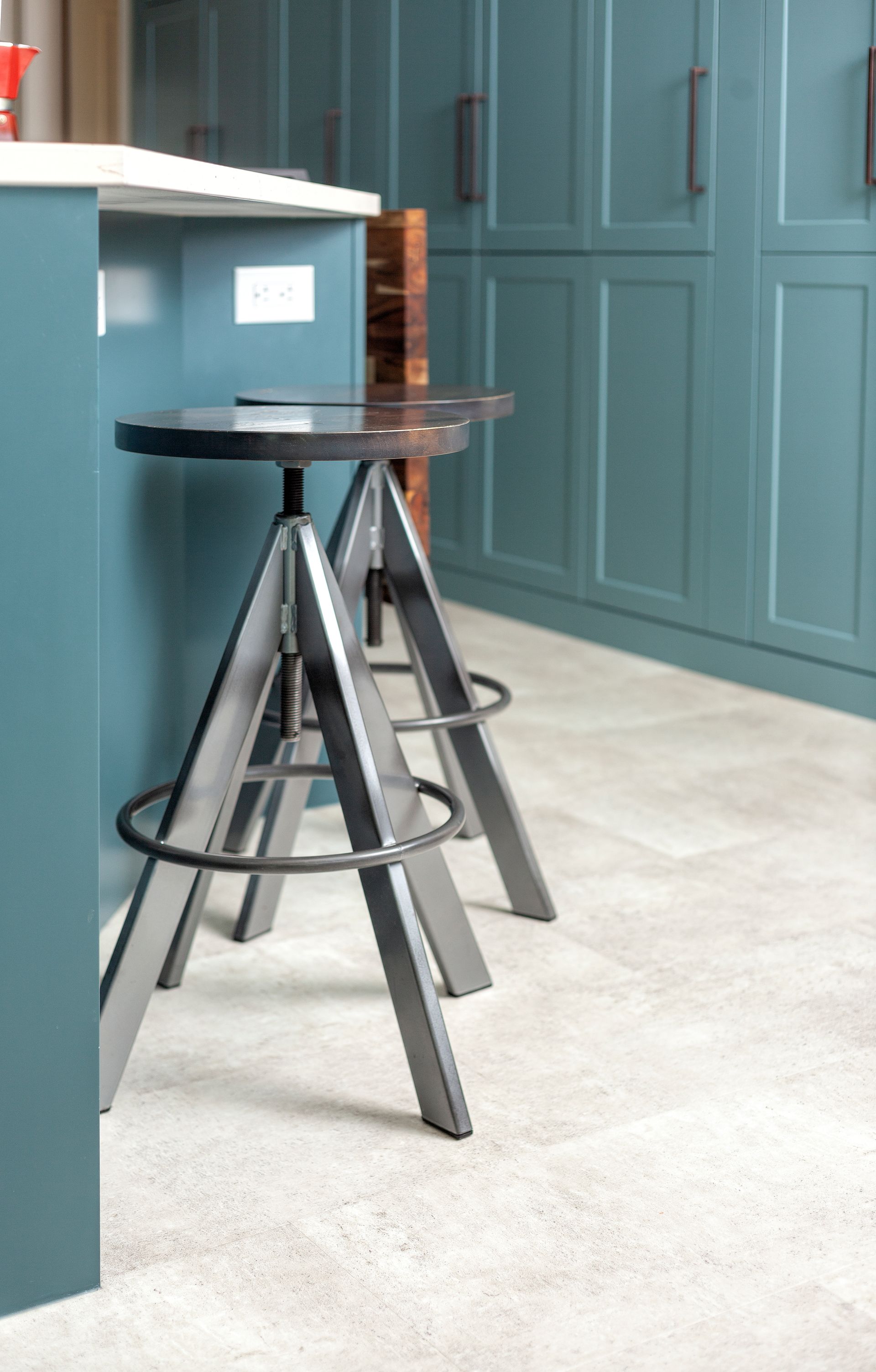 Two bar stools are sitting next to each other in a kitchen.