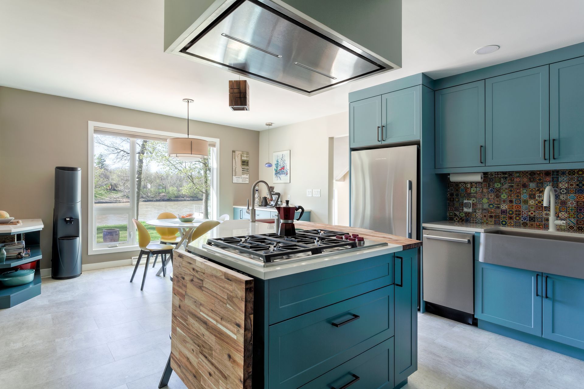 A kitchen with blue cabinets and a stove top oven.