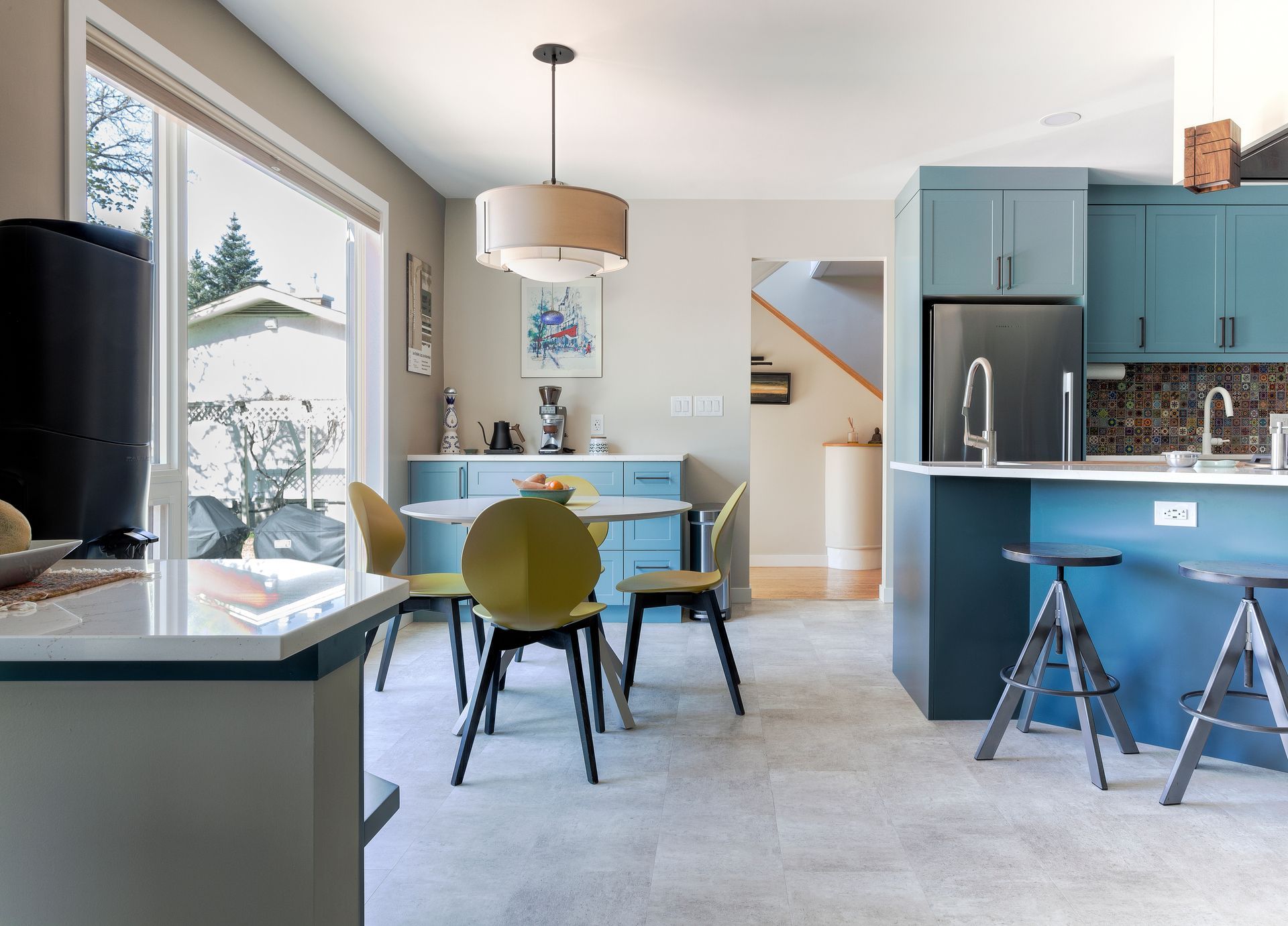 A kitchen with blue cabinets and a table and chairs