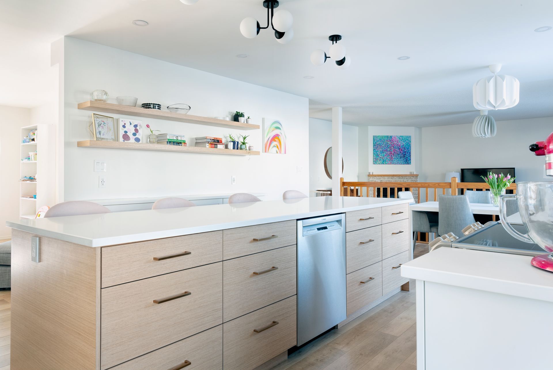 A kitchen with wooden cabinets and a stainless steel dishwasher.