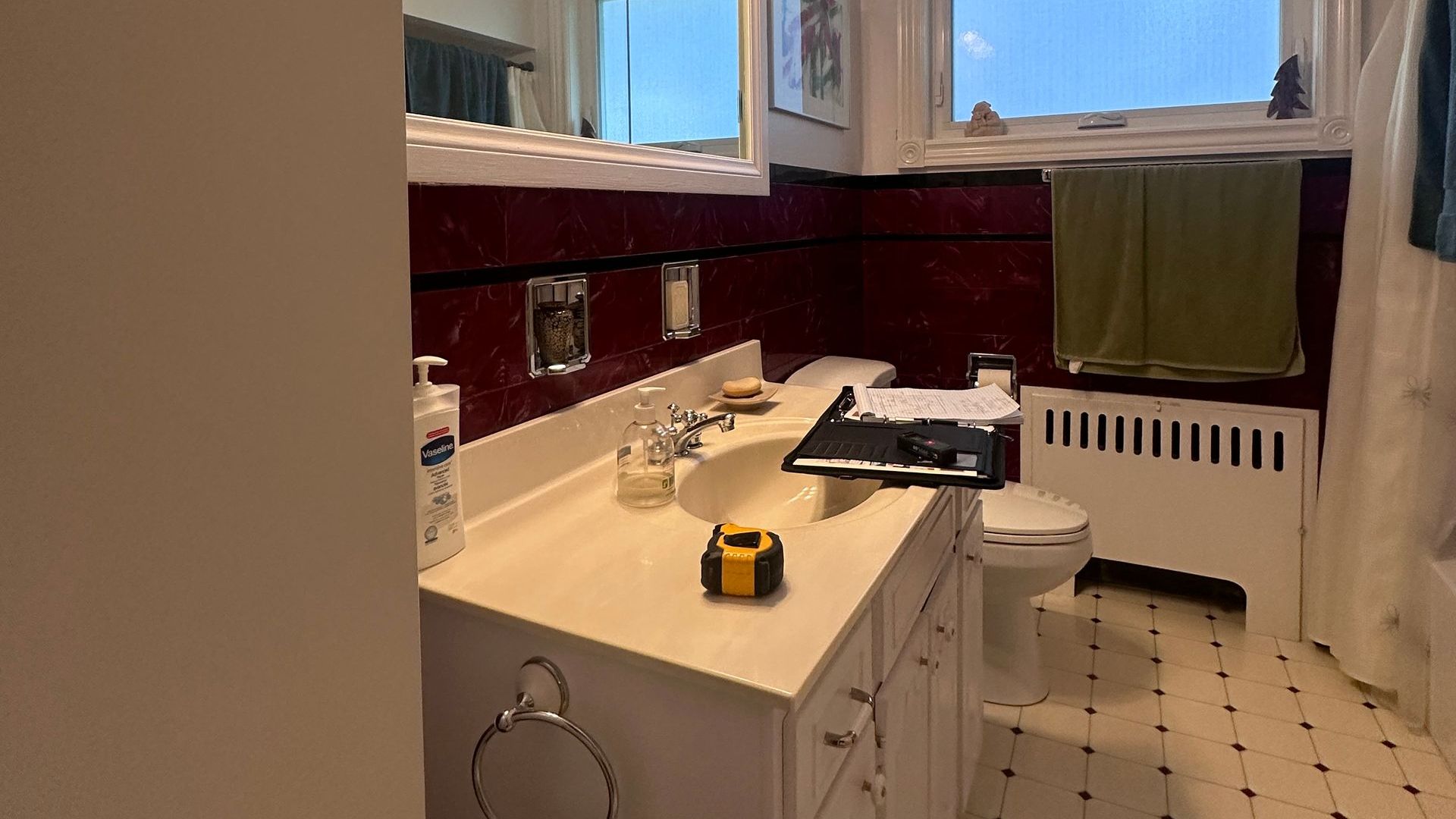 A bathroom with a sink a toilet and a window