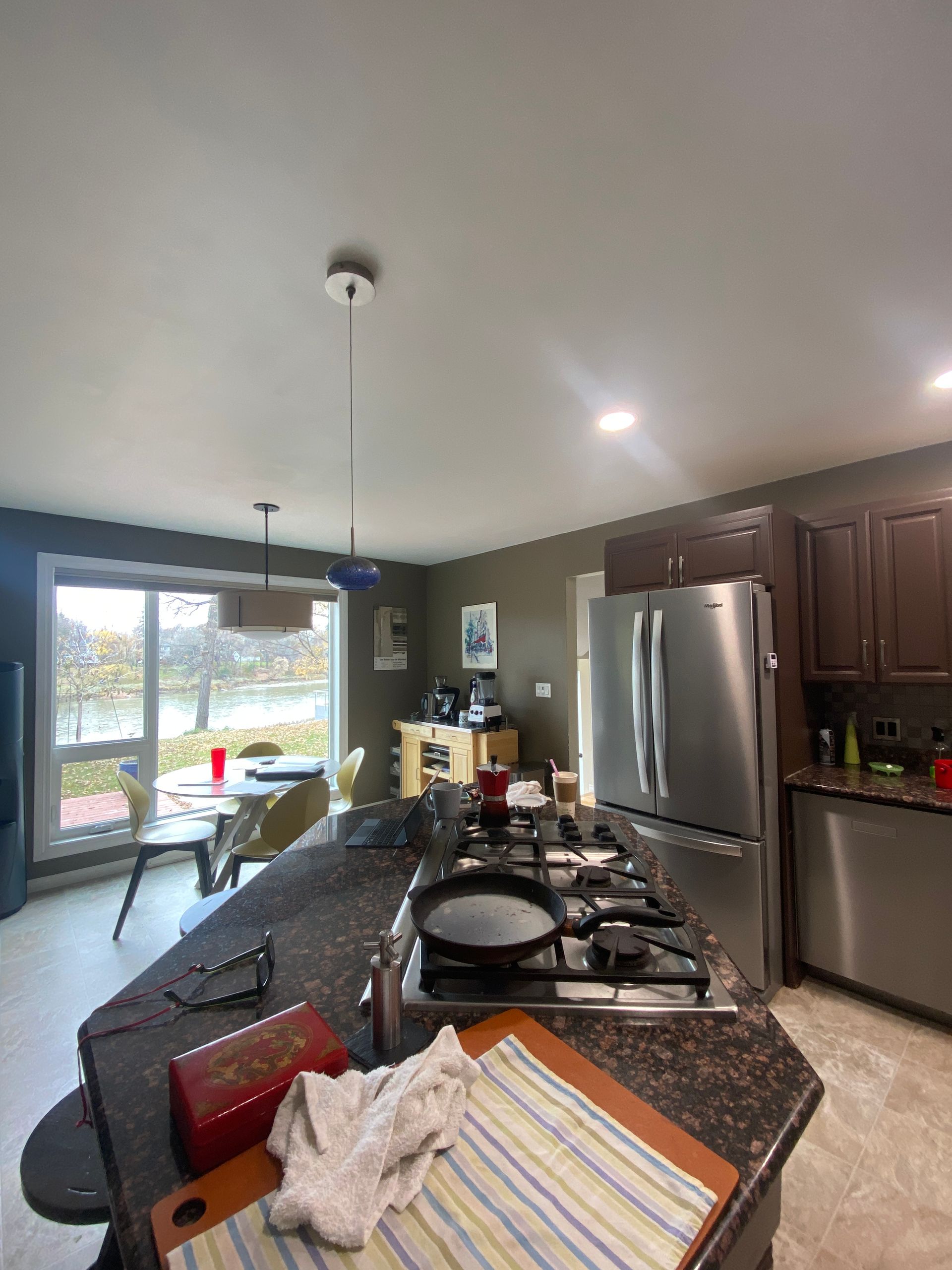 A kitchen with a stove top oven and a refrigerator