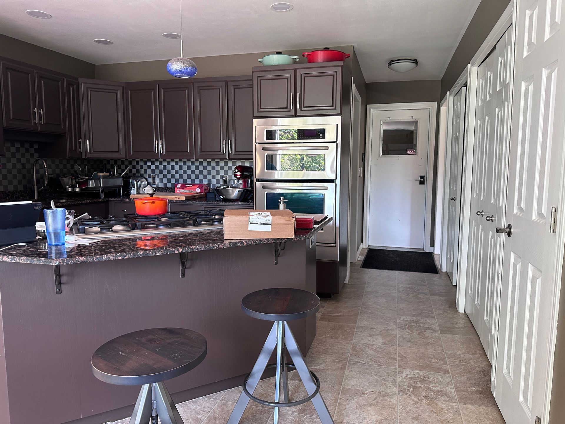 A kitchen with stools and a box on the counter