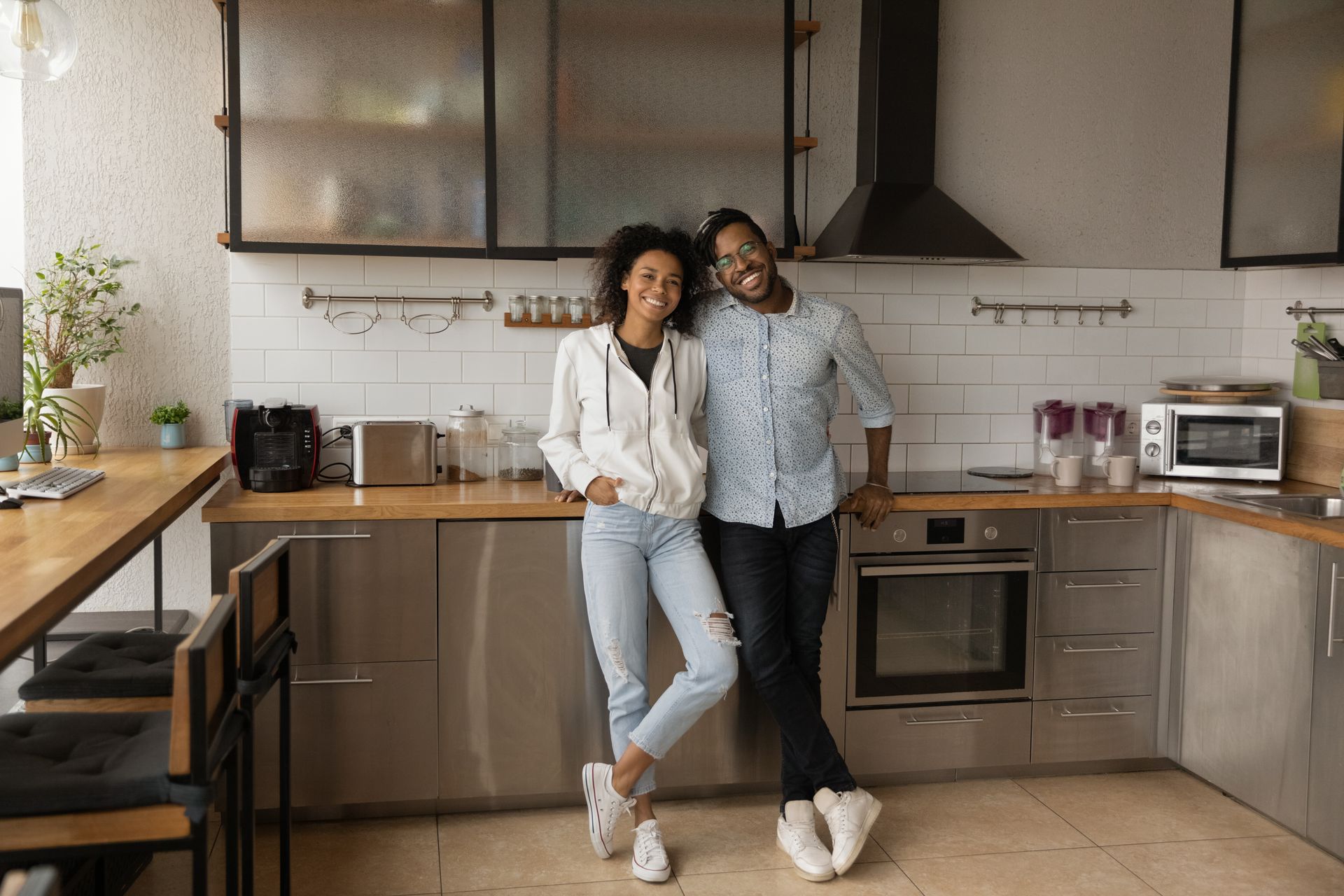 A man and a woman are standing in a kitchen.