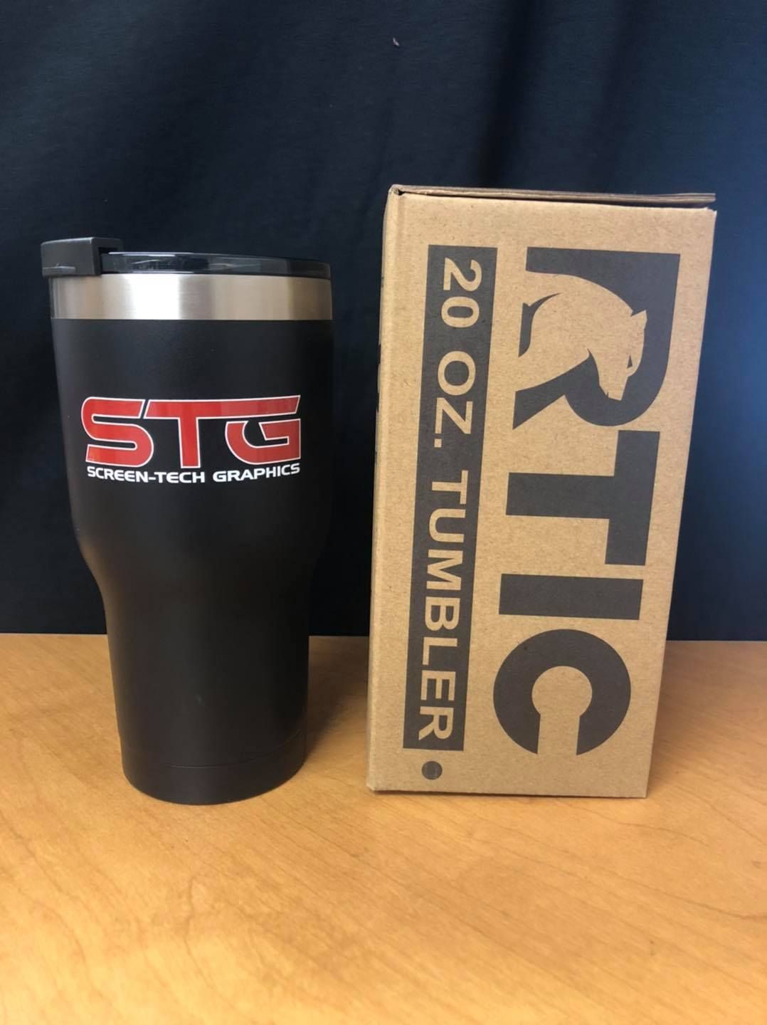 A rtic 20 oz tumbler sits next to its box