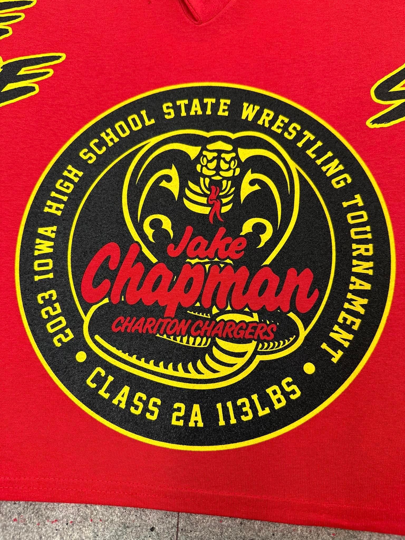 A red shirt that says iowa high school state wrestling tournament
