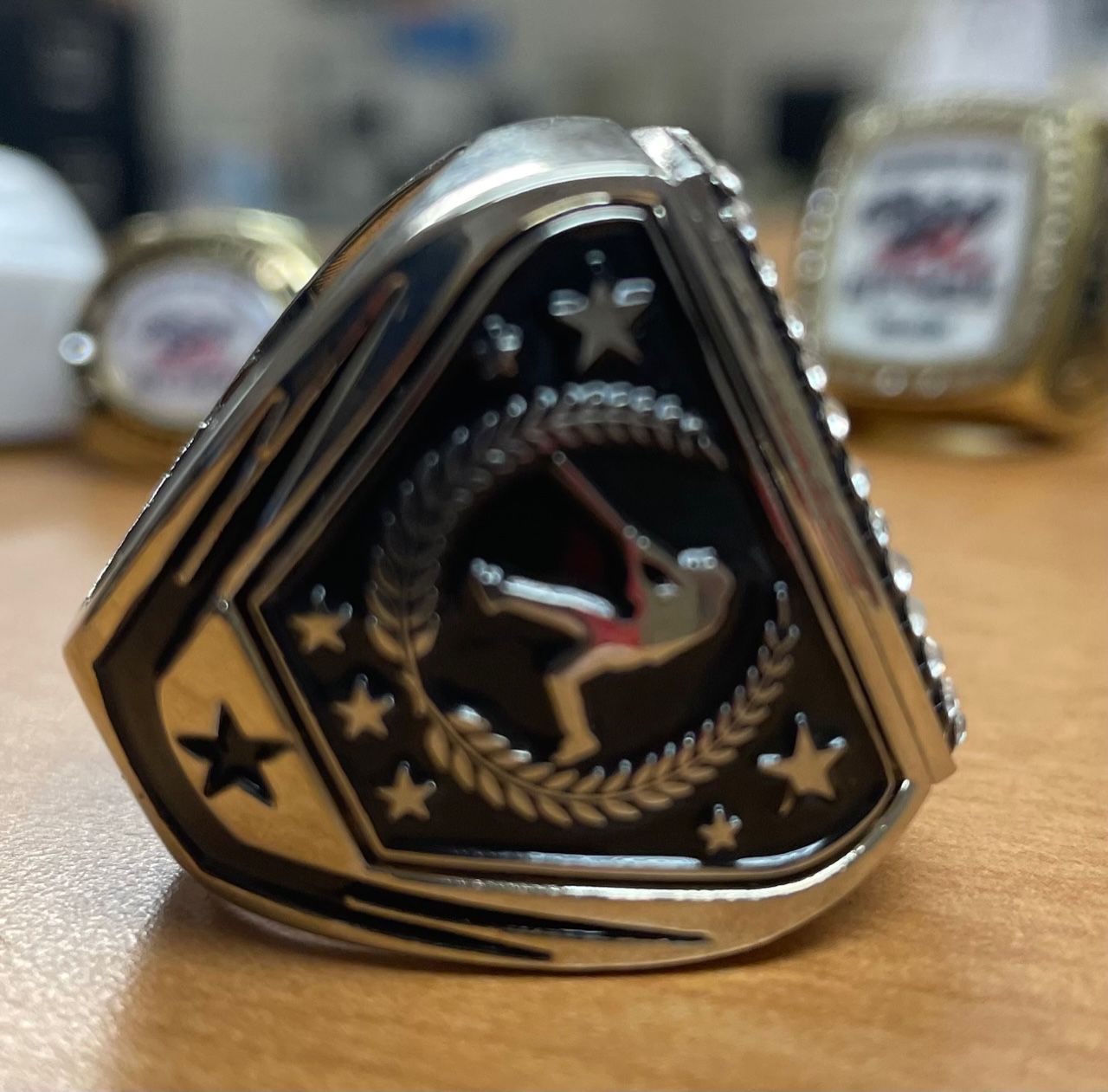 A silver ring with a picture of a gymnast on it