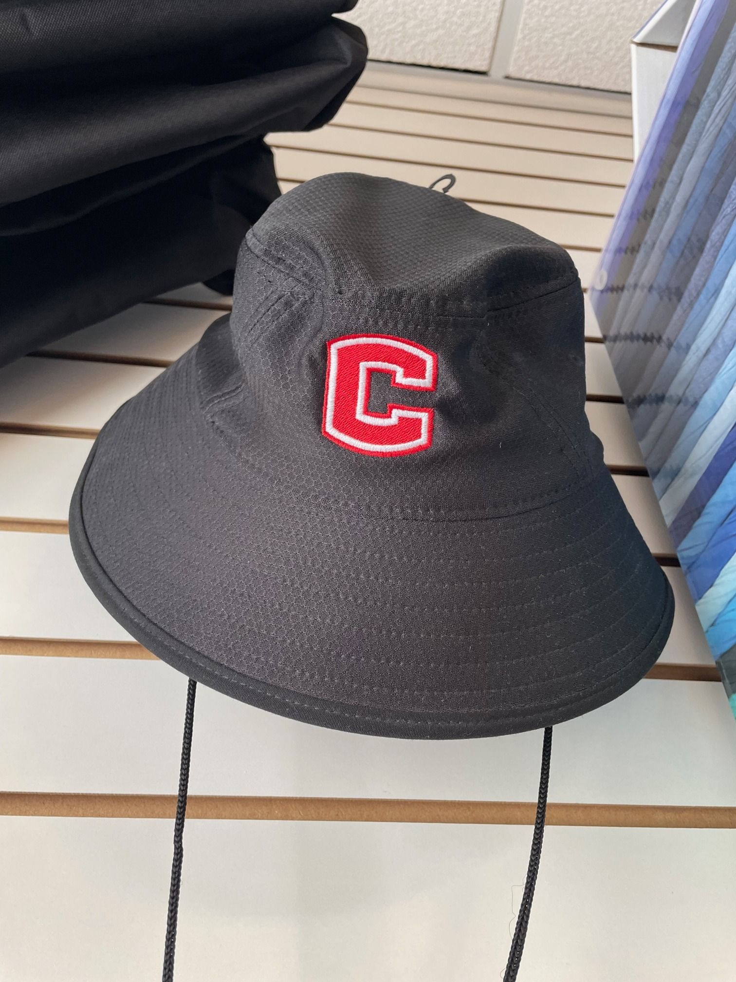 A black hat with a red letter c on it