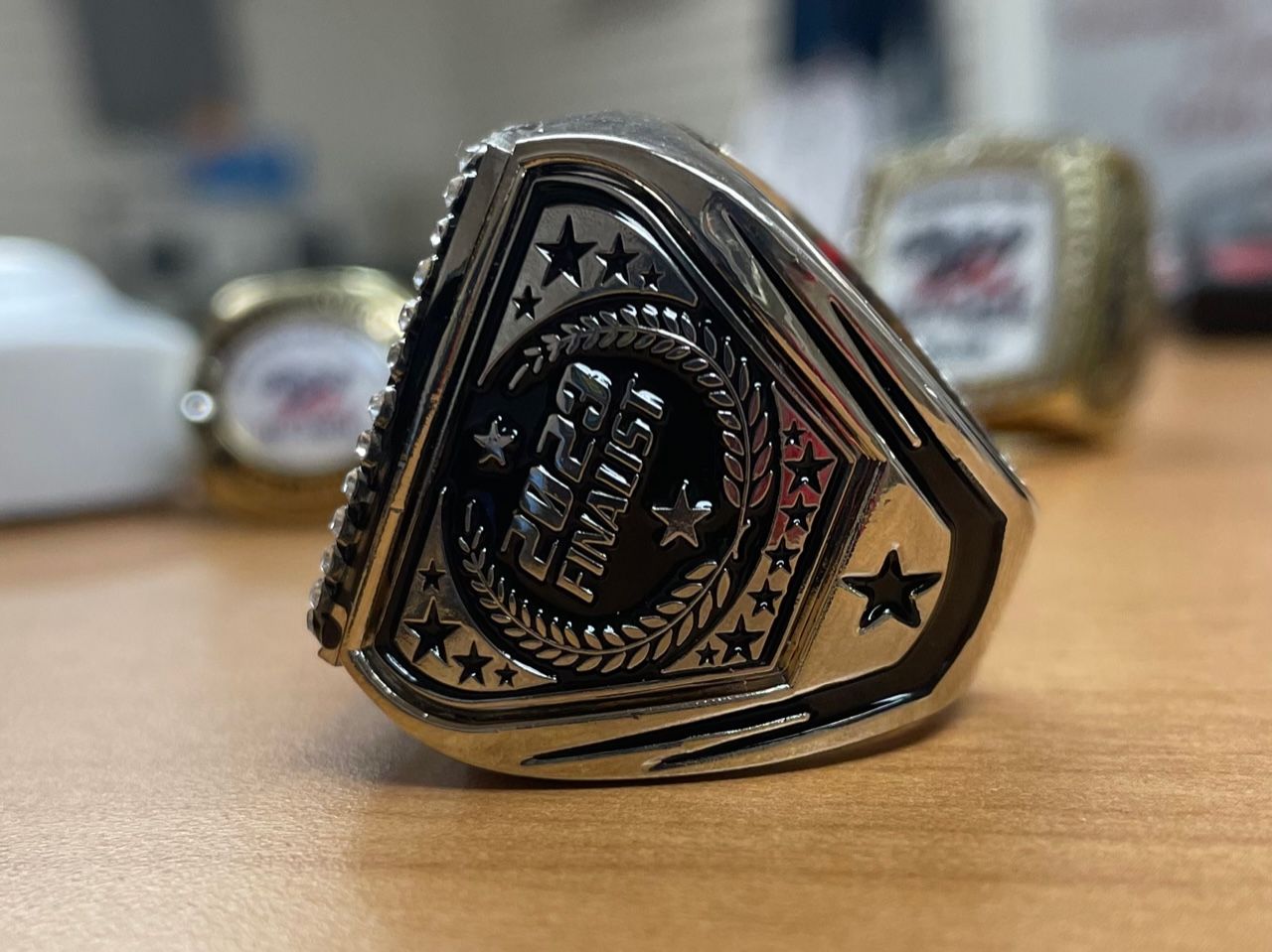 A silver ring that says ' 2021 finalist ' on it