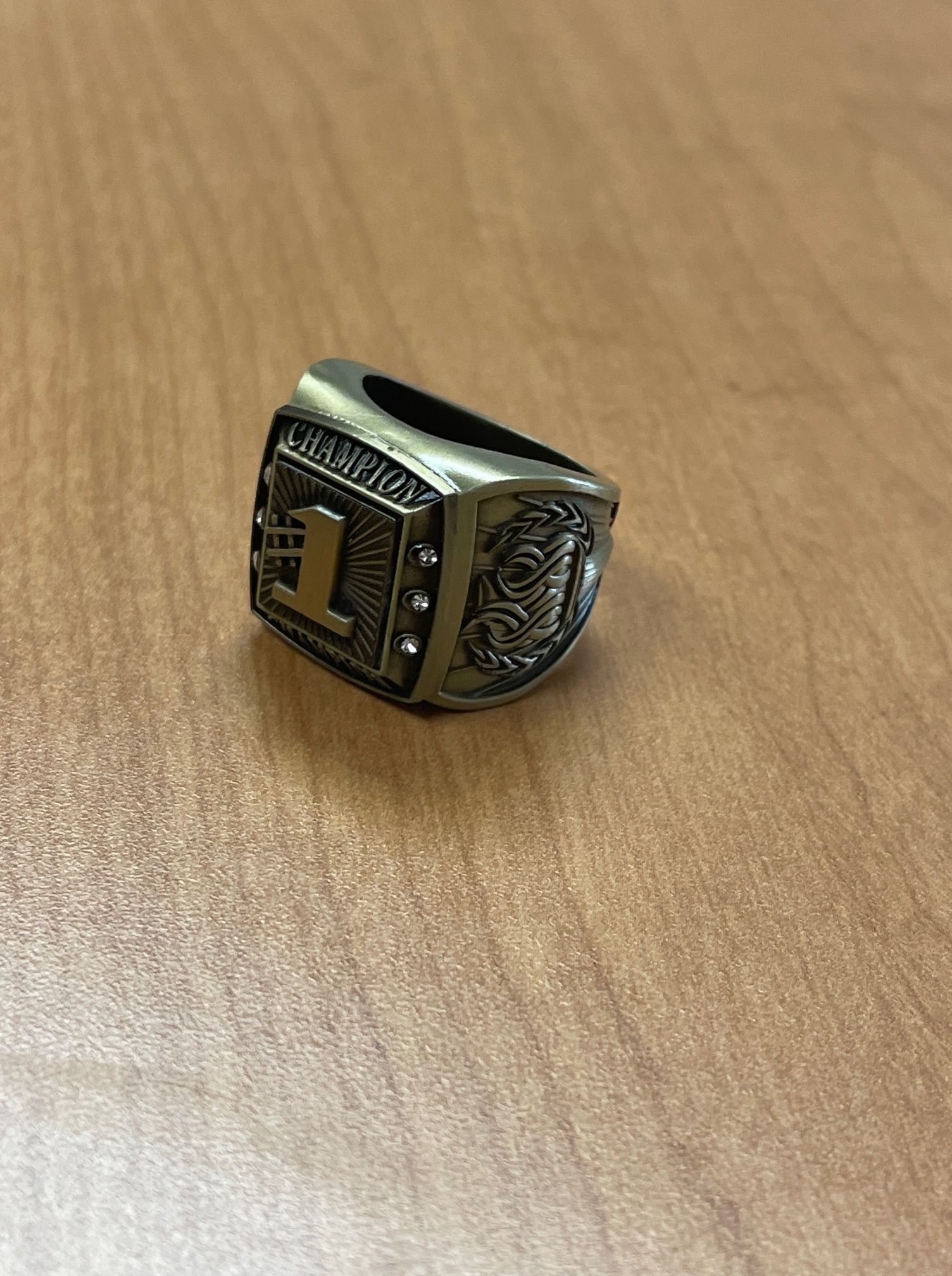 A ring is sitting on a wooden table.