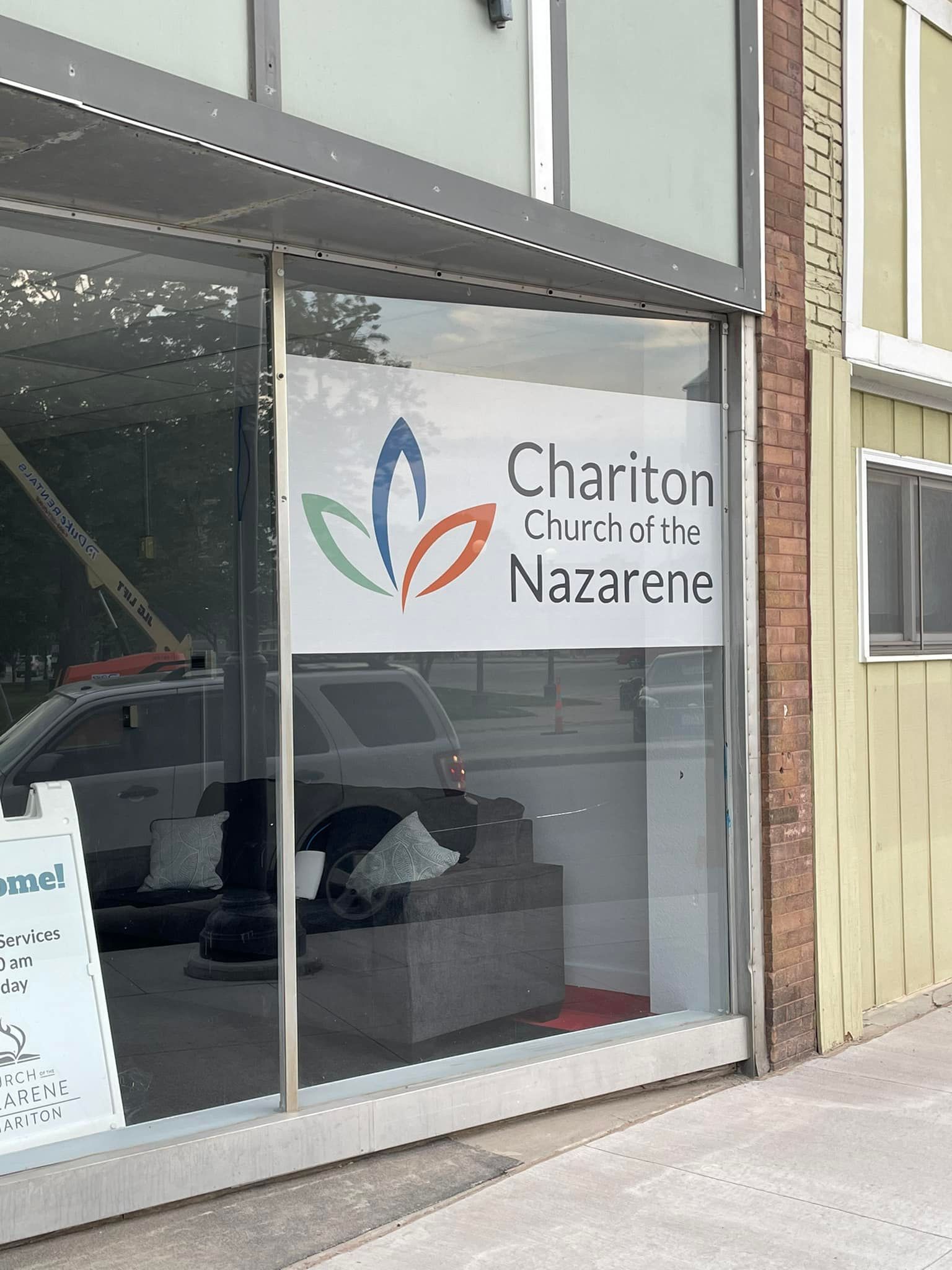 A store front with a sign that says ' chariton church of the nazarene ' on it.