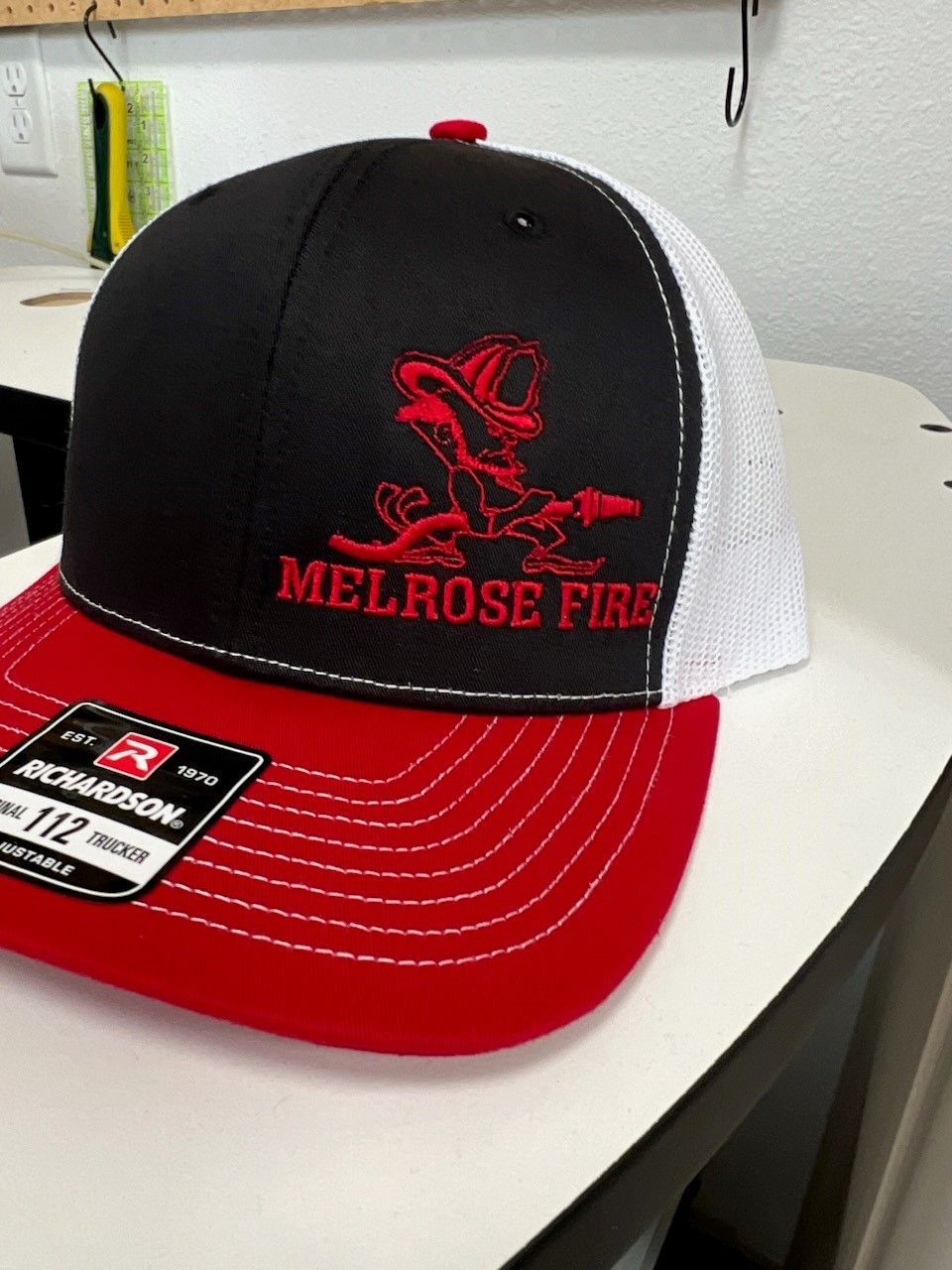 A melrose fire hat is sitting on a table
